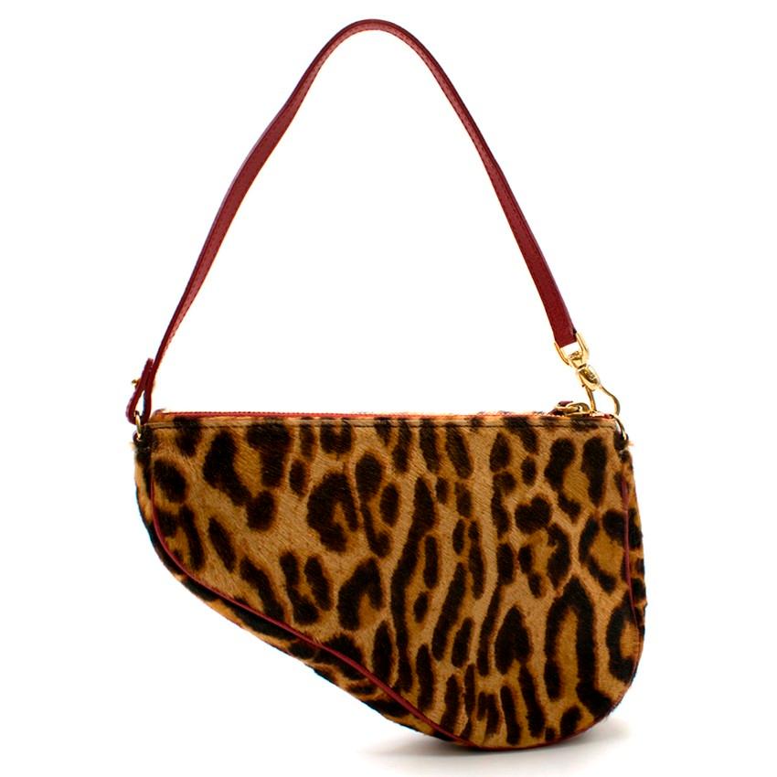 Dior Vintage Leopard Print Pony Hair Saddle Bag

-Leopard print saddle bag
-Red trim and strap
-Gold toned hardware
-Zip closure
-One interior pocket

Please note, these items are pre-owned and may show signs of being stored even when unworn and
