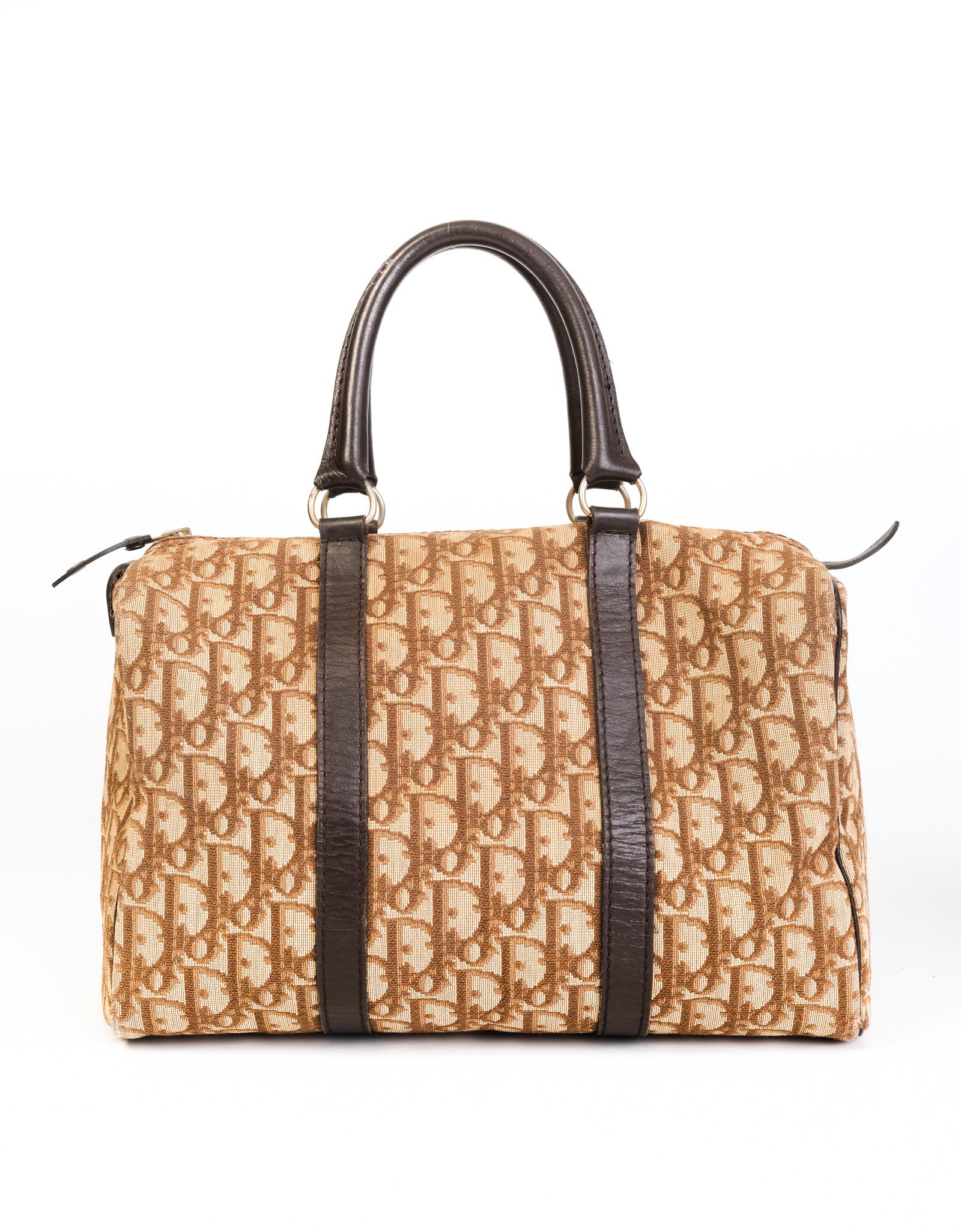 Classic Dior Boston/Bowler bag measuring 30-cm in length and made with tan and brown monogrammed canvas. Featuring supple brown leather trimming throughout, dual roller leather top handles with gold toned links and woven fabric interior