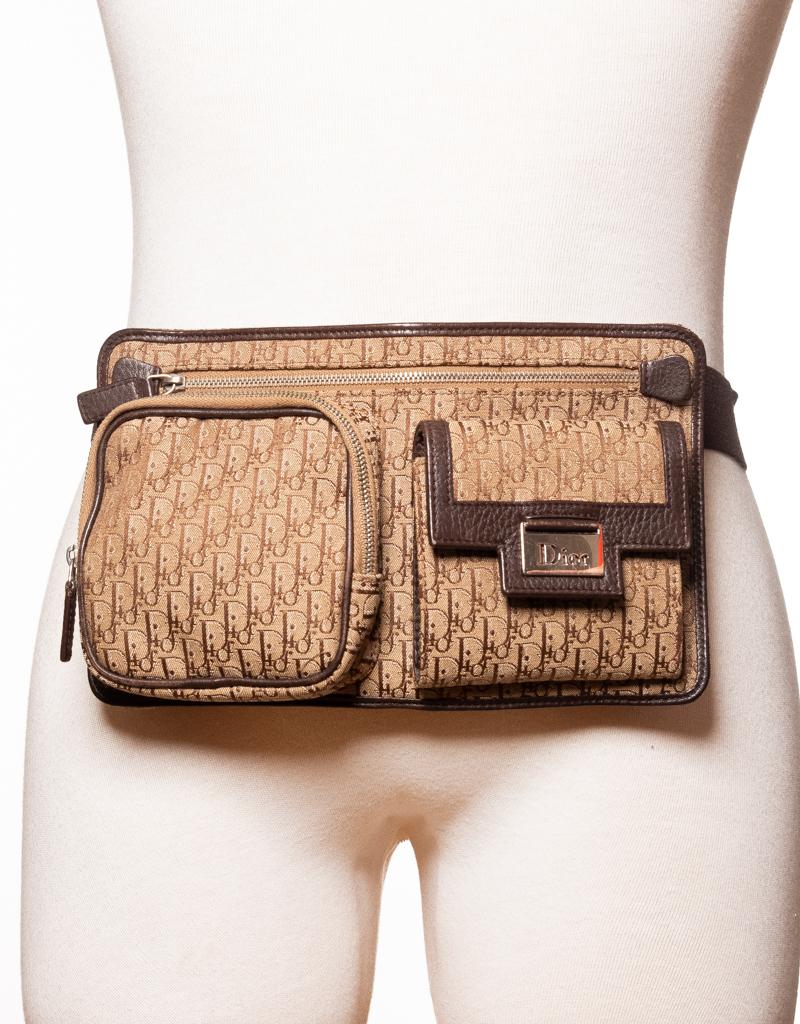 This Dior belt bag from the Street Chic collection is made of canvas with leather finishes. Featuring a beige canvas with Dior’s Trotter monogram print in brown, gold tone hardware, a front zip pocket, a front pocket with flap, top zip closure to