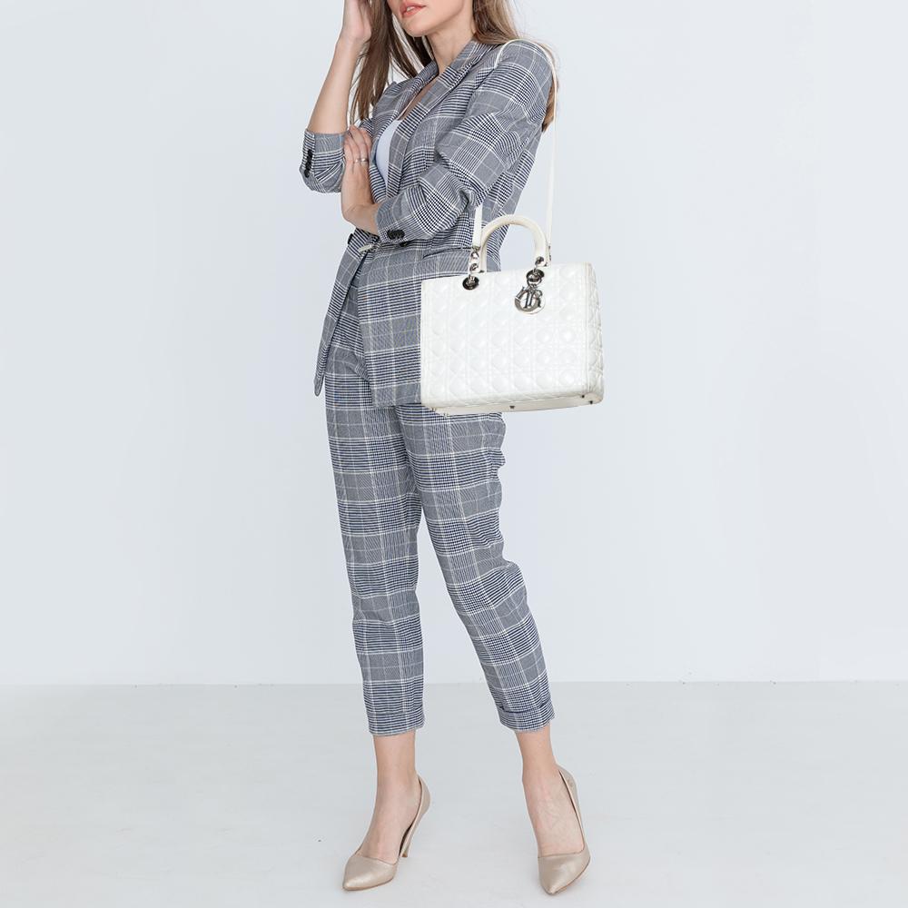 The Lady Dior tote is a Dior creation that has gained recognition worldwide and is today a coveted bag that every fashionista craves to possess. This white tote has been crafted from leather and it carries the signature Cannage quilt. It is equipped