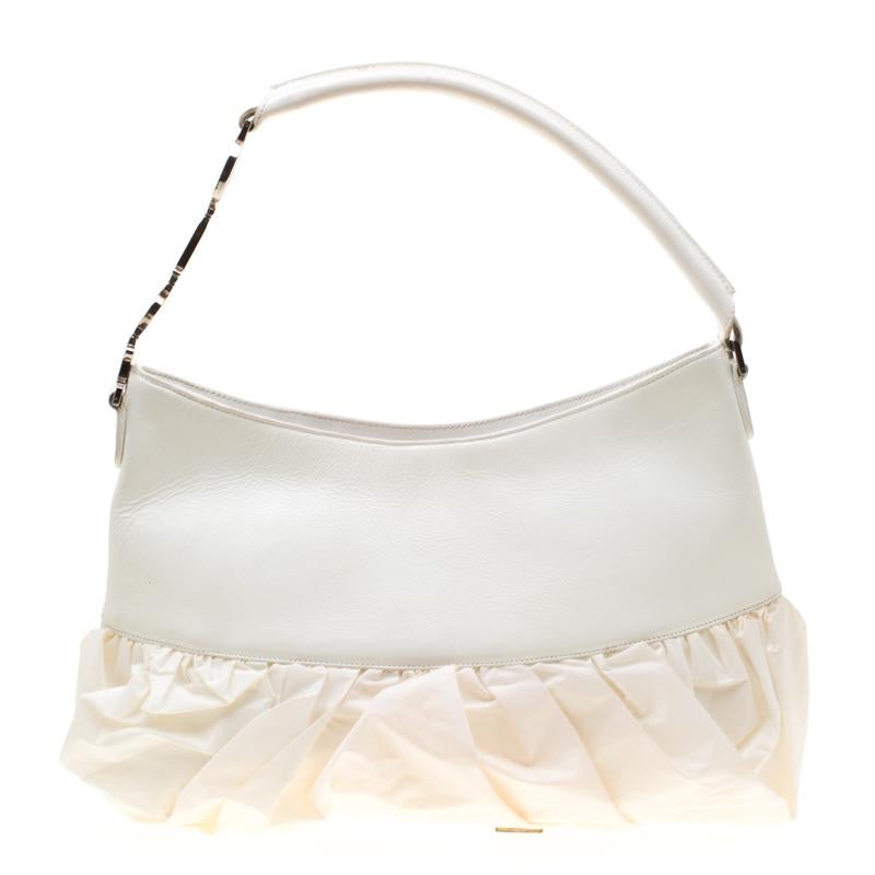Featuring a fabric lining and designed for better utility, this bag will be your essential companion. Dazzle your audience with this contemporary and grand leather and fabric handbag. Designed by Dior, this white bag makes for a refreshingly unique