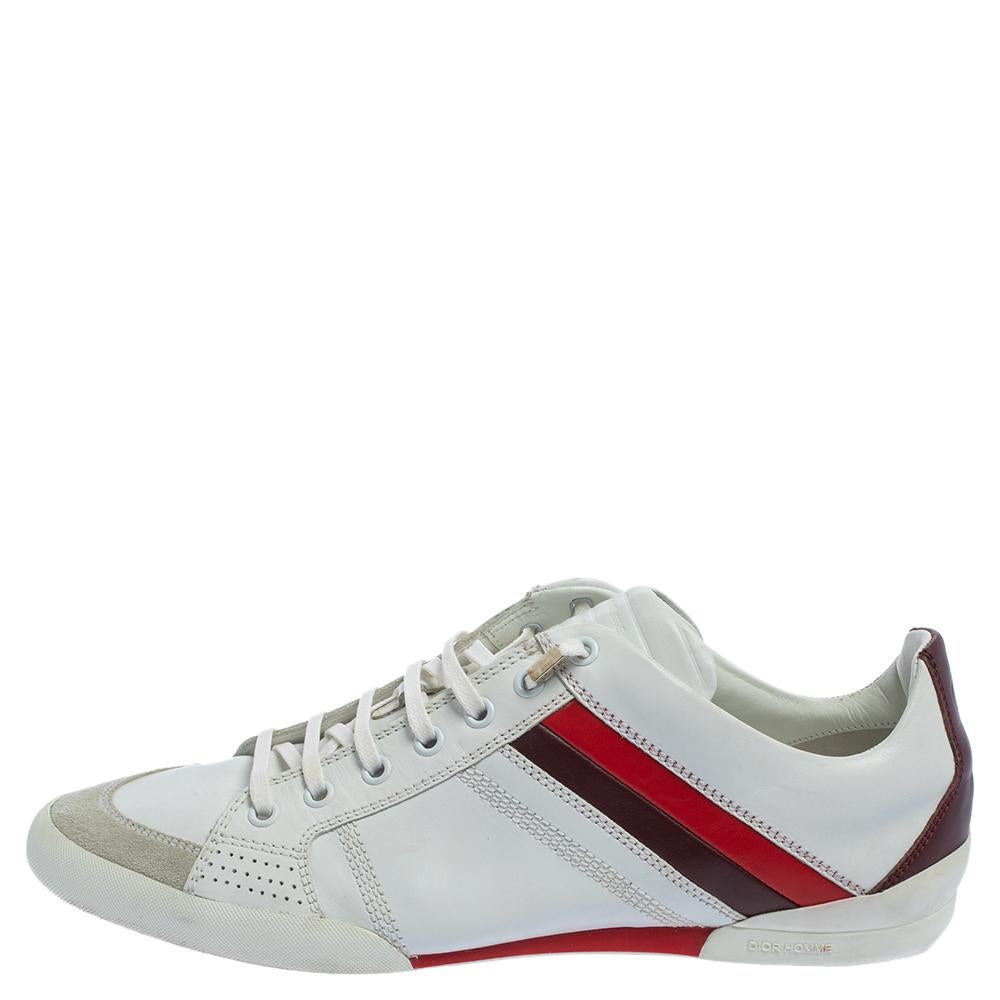 Ace the sneaker style with these white ones from Dior. They are crafted from leather and suede and feature round toes, lace-ups on the vamps, contrasting stripes on the sides, and 'CD' logo details on the counters. They are endowed with comfortable
