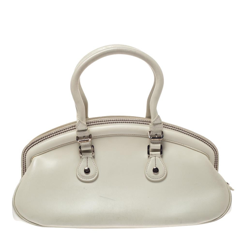 This detective satchel from Dior is a stylish way of carrying your essentials. Crafted from white leather, it has two handles and the brand initials hanging over the front pockets. The zip-top closure opens to a fabric-lined interior that houses a