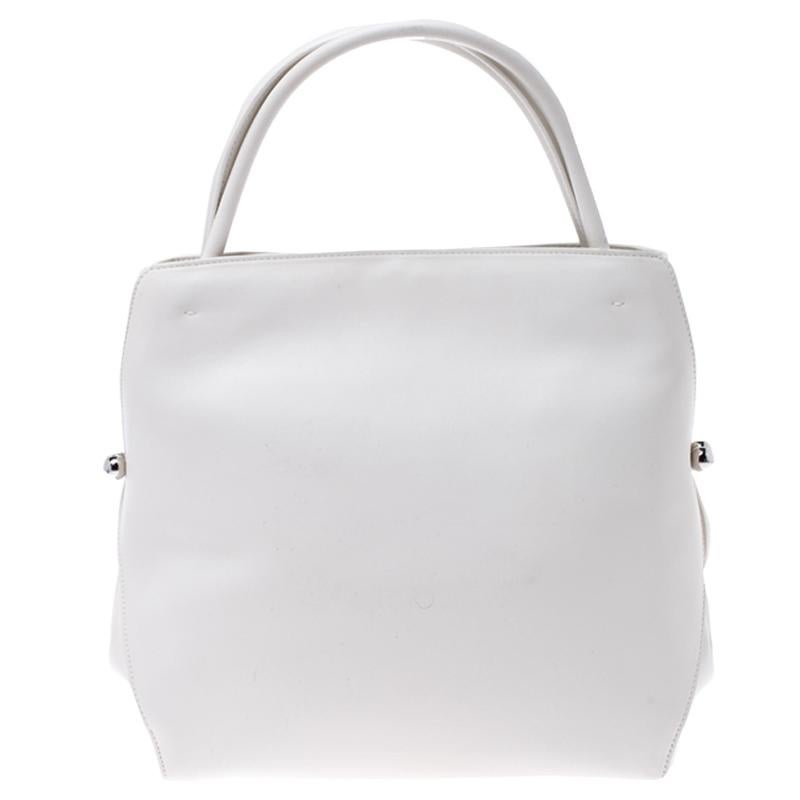 Look elegant and feminine wearing this Dior Bar tote which is big enough to hold all that you need and more along with a beautiful design that will never let you down. Crafted in white leather, this bag features a drawstring closure, two top handles