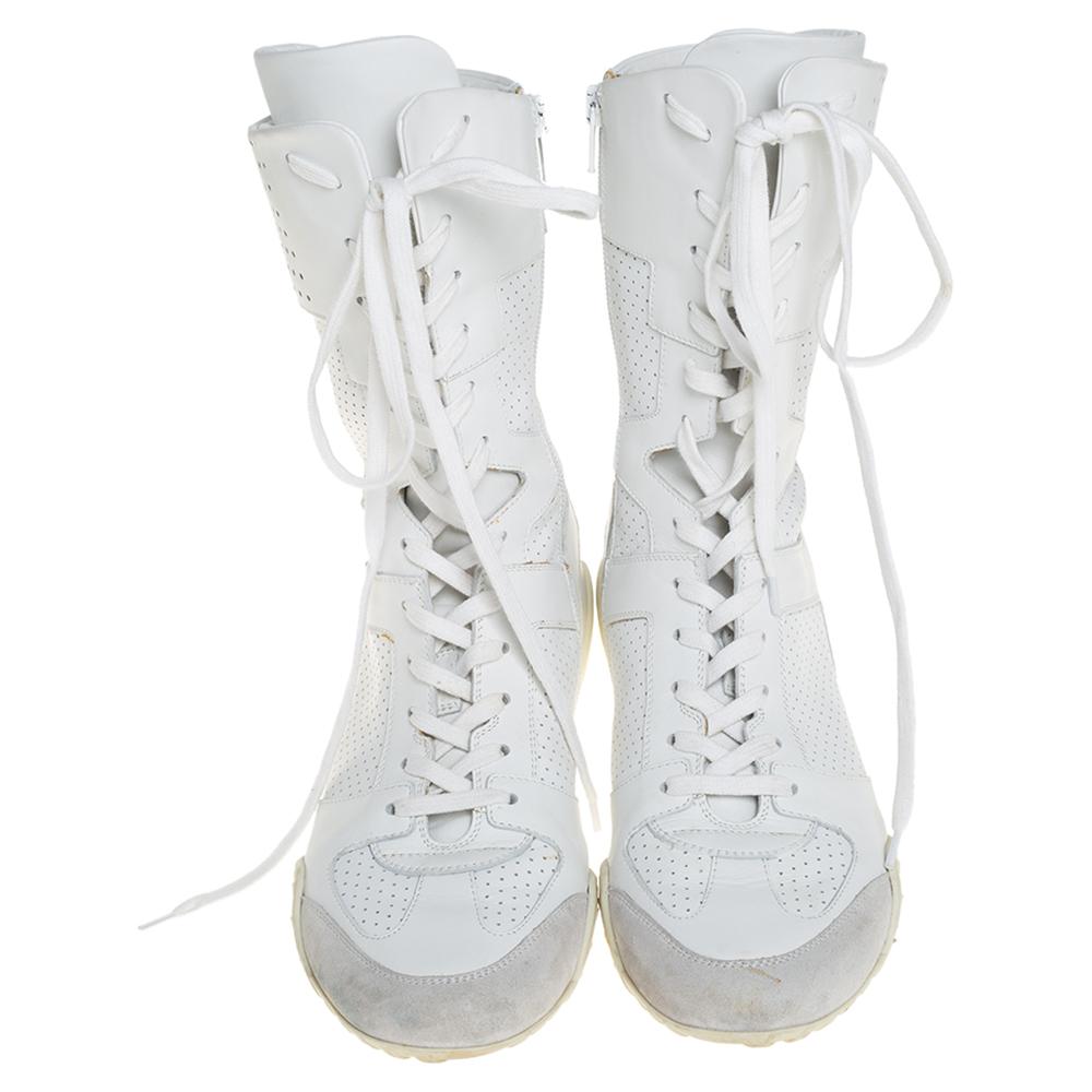 Make these stylish leather and suede boots yours this season. They are designed with a perforated pattern on the exterior and J'adior signature on the counters. These sneaker boots, equipped with rubber soles, are simple yet chic. Flaunt your style