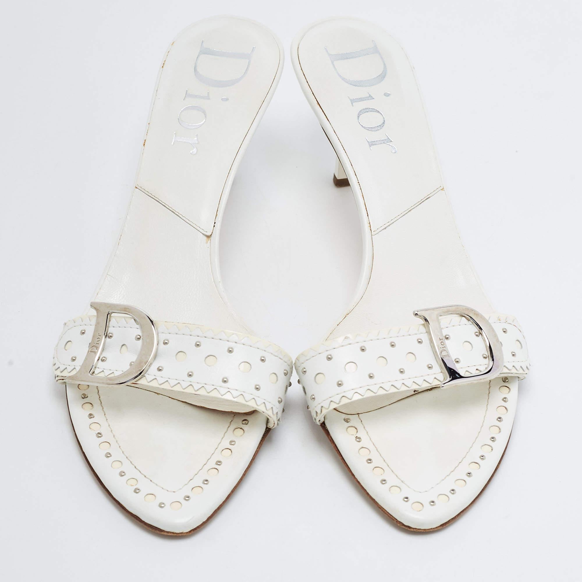 Lend an elegant finish to your look of the day with these Dior white leather sandals. They feature open toes and kitten heels.

Includes: Branded Box