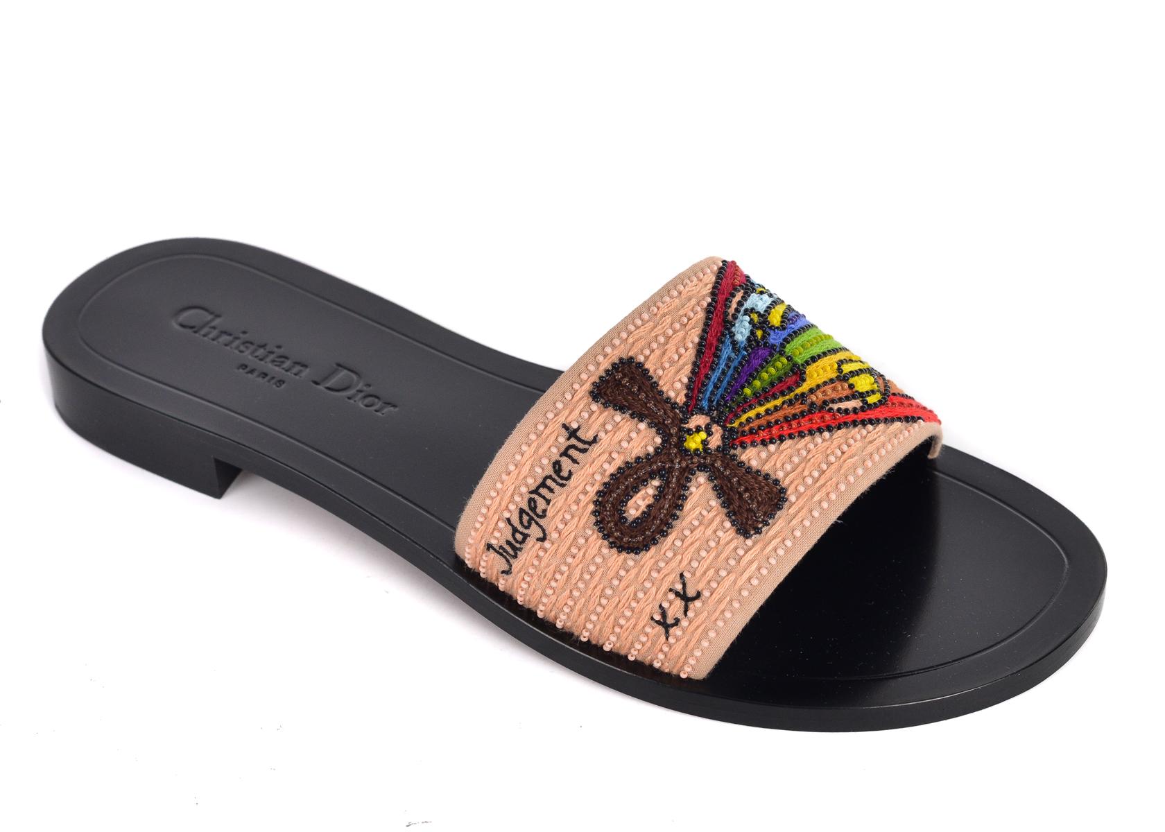 Christian Dior's Dior Tarot Judgement Embroidered Slippers. These slippers are crafted with intricate embroidered designs for a chic edgy look. Pair with regular denims for those slipper clogs for a chic everyday look.

Christian Dior's Dior