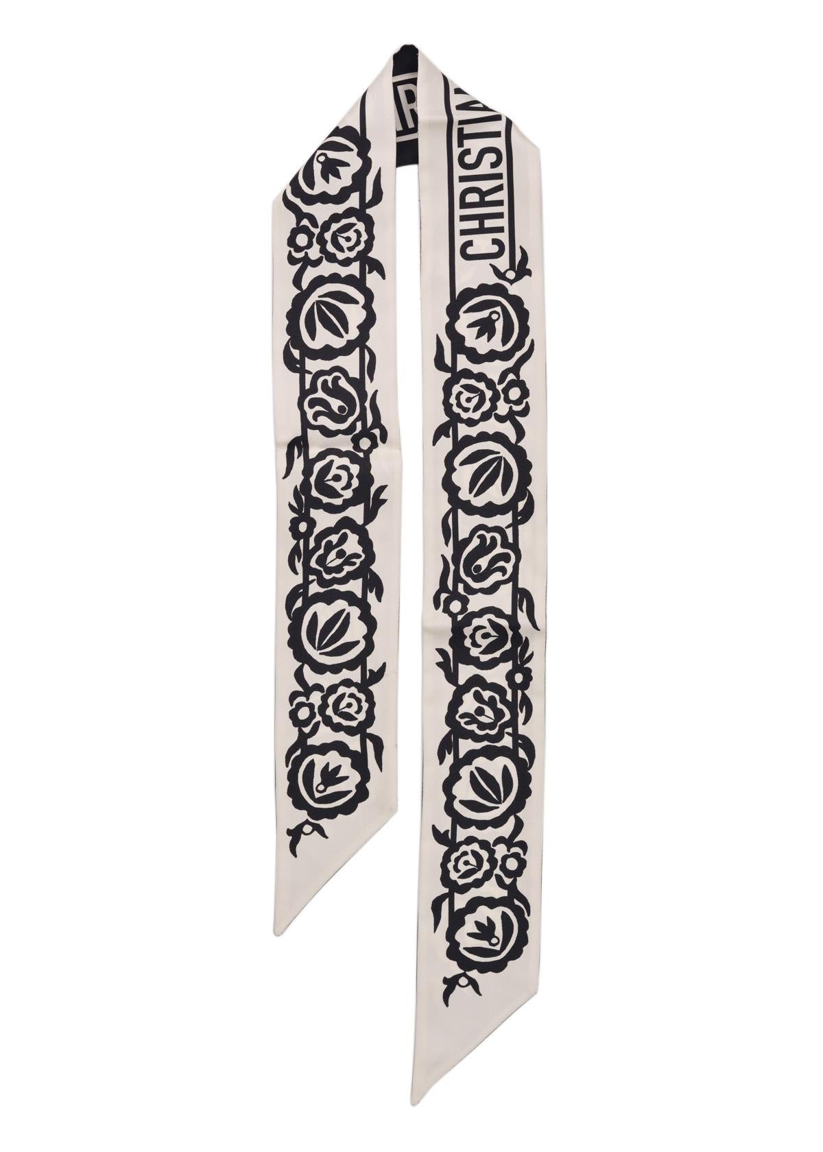 Dior floral logo mitzah skinny scarf. This scarf is crafted from luxurious silk for a luscious soft sensation. Perfect to style on a gorgeous handbag handle or along the neckline for a sophisticated feminine look.

Dior Floral Logo Mitzah Skinny