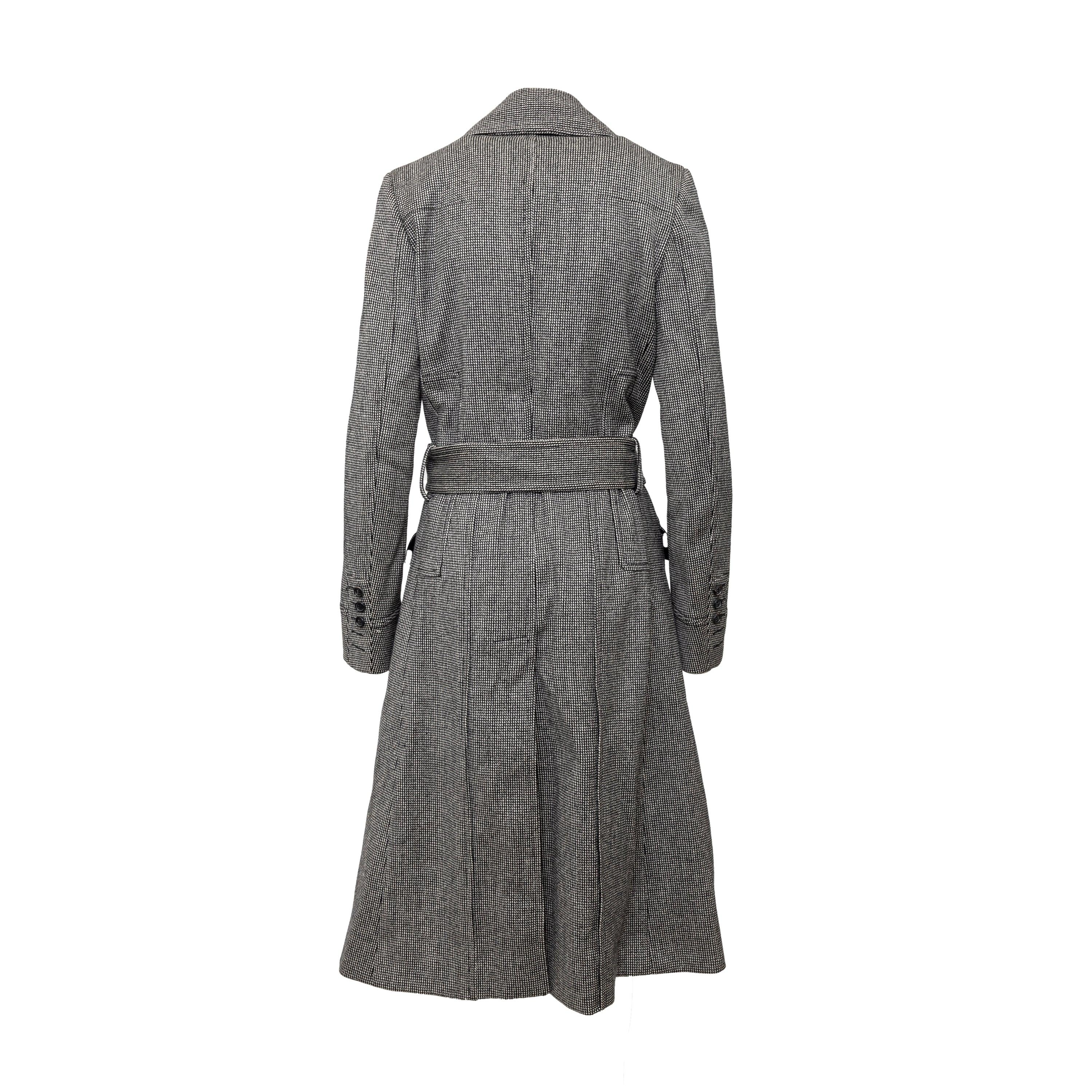 Crafted from 100% wool, the Dior overcoat boasts a distinctive stitching pattern. With a lapel collar, open front, and buckled belt, this overcoat is both stylish and functional. Complete with front flap