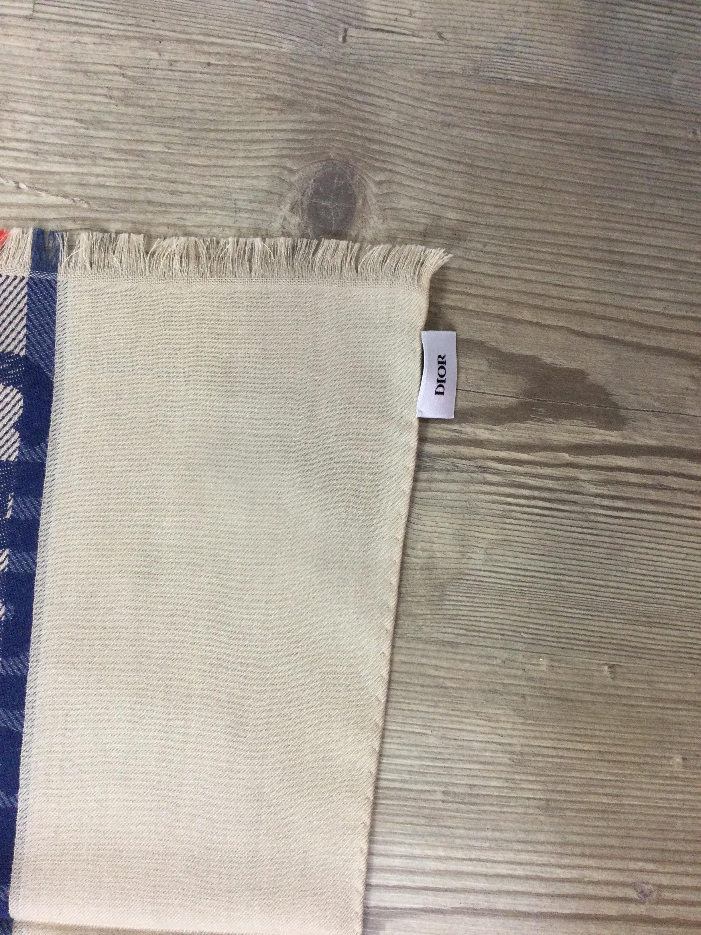 Dior Stole. 
In wool, silk & cashmere.
Featuring small fringes along short sides
Measurements: 200cm X 70 cm.
Conditions: Good - Previously owned and gently worn, with little signs of use. May show slight pilling, pulls or fading.