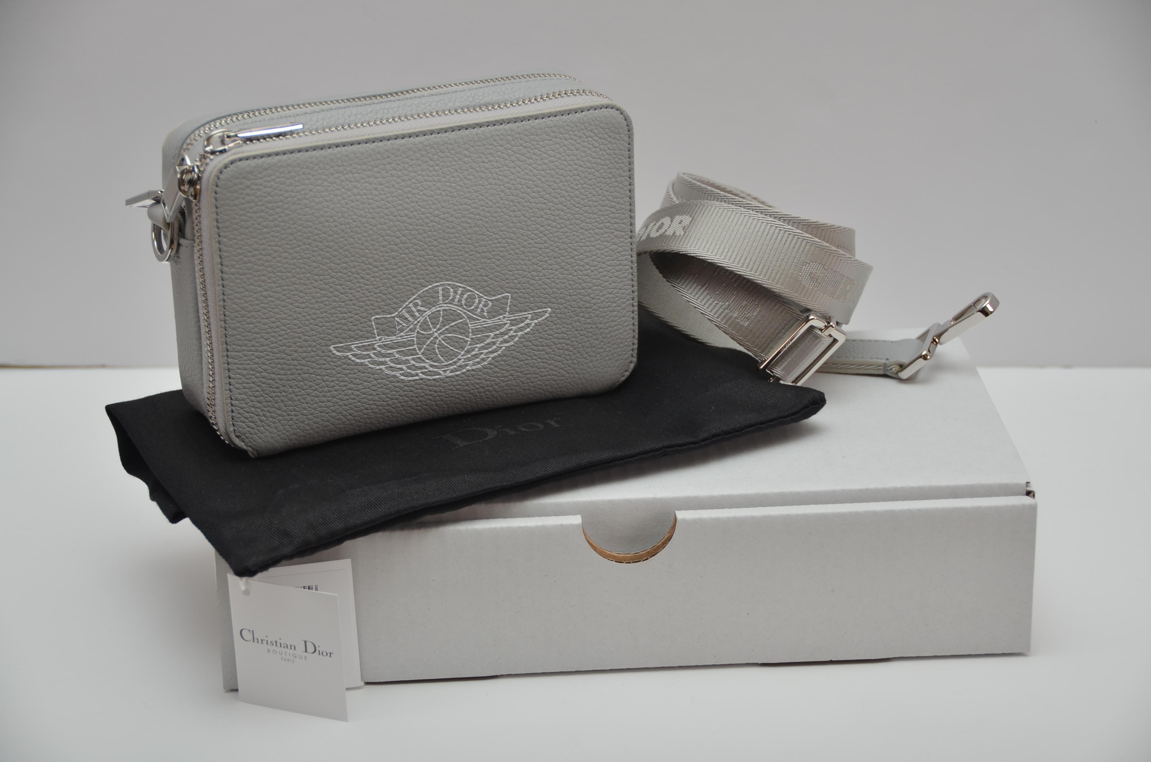 
100% guaranteed authentic 
Dior X Jordan AirDior  Grey  Crossbody Messenger Bag
For the Men’s Fall 2020 Runway show in Miami, Dior and Kim Jones partnered with Jordan Brand to unveil the limited-edition Air Jordan collaboration  

COLOR: light grey