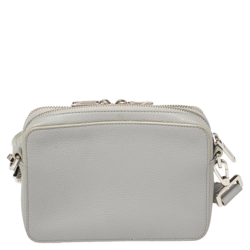 A special creation from the Dior x Jordan Brand Fall 2020 Capsule Collection. Known as the Air Dior Wings messenger bag, this creation is delivered in grey-hued leather with logo detailing on the front. The bag has a compact size, a broad shoulder
