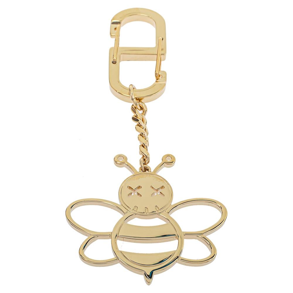 Add an element of fun and playfulness with this Dior x Kaws keychain. Crafted from gold-tone metal, it features a bee motif with signature Kaws eyes attached to a clasp fastening with the help of a chain.

Includes: Original Dustbag, Brand Paper Bag