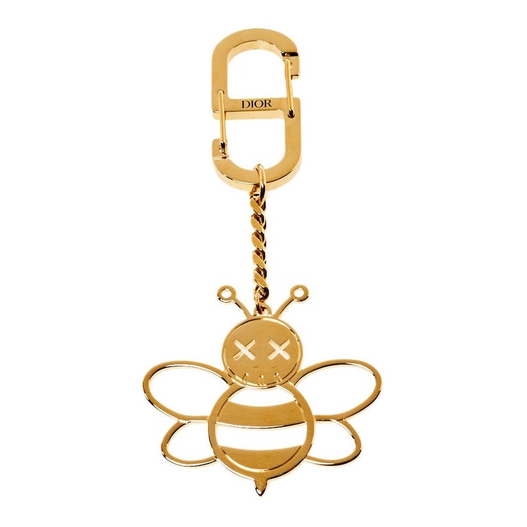 Dior x Kaws Gold Tone Bee Charm Keychain at 1stDibs  dior kaws keychain,  dior keychain, dior phone charm