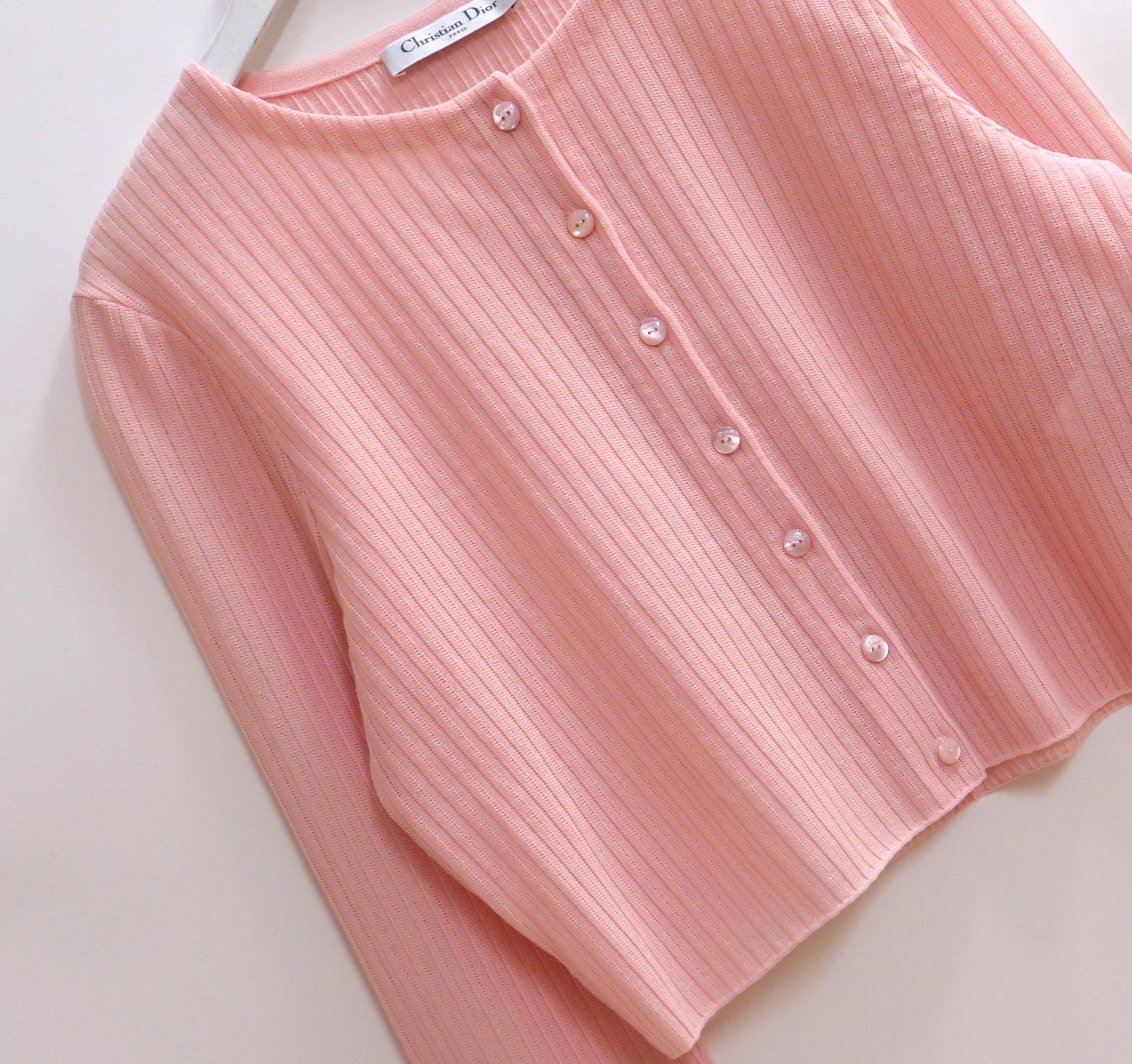 Ultra luxe Dior pink cardigan from Raf Simons’ Spring 2015 collection. Bought for £1950 and unworn. Crafted from beautifully textured candy pink cotton and polyamide, it has little Dior etched pink mother or pearl buttons. Has a boxy cut with