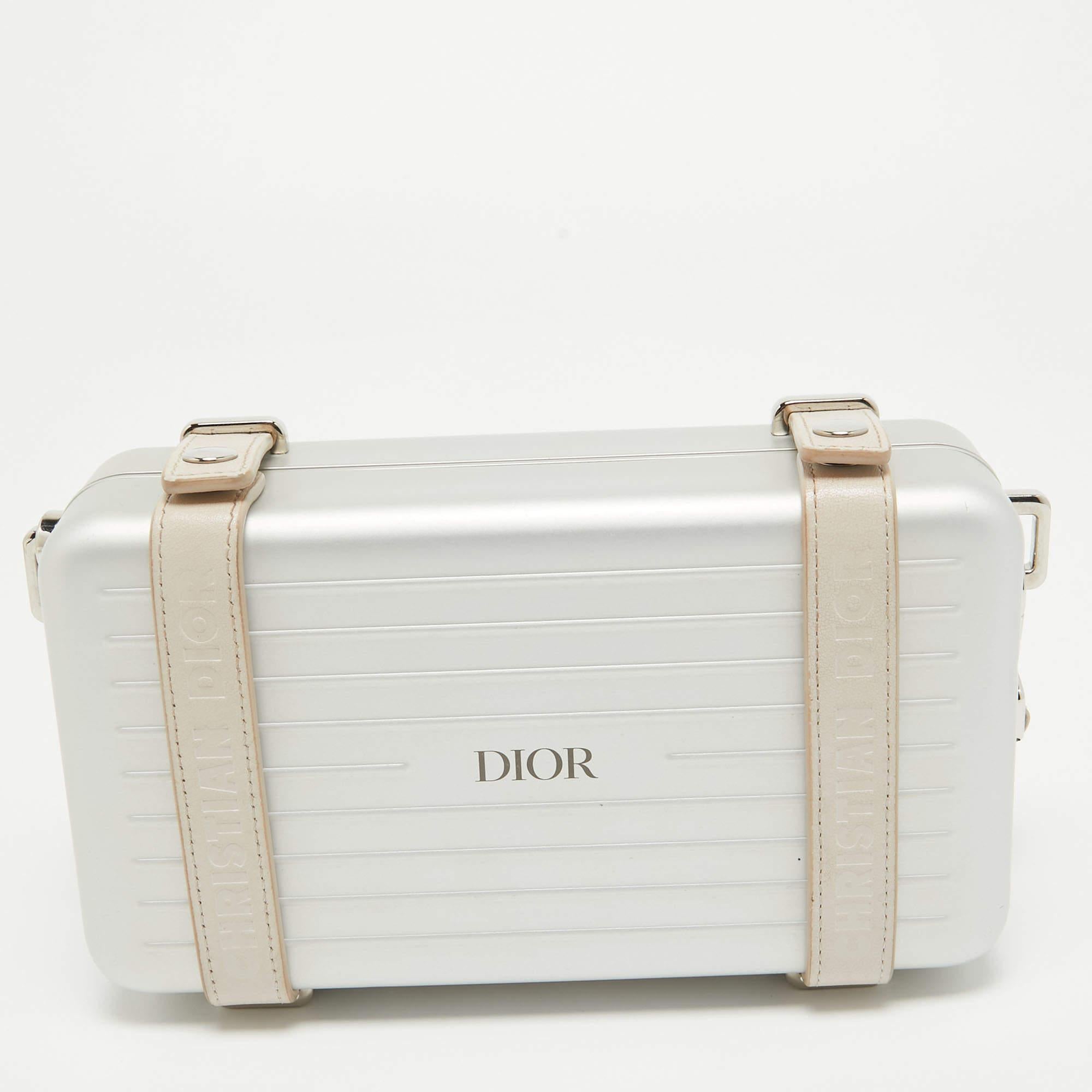 The personal clutch is from a special collaboration between DIOR and RIMOWA. Made from lightweight aluminum, the clutch has a compact size that makes it ideal to be carried by hand. The leather straps with snap fasteners secure the well-lined