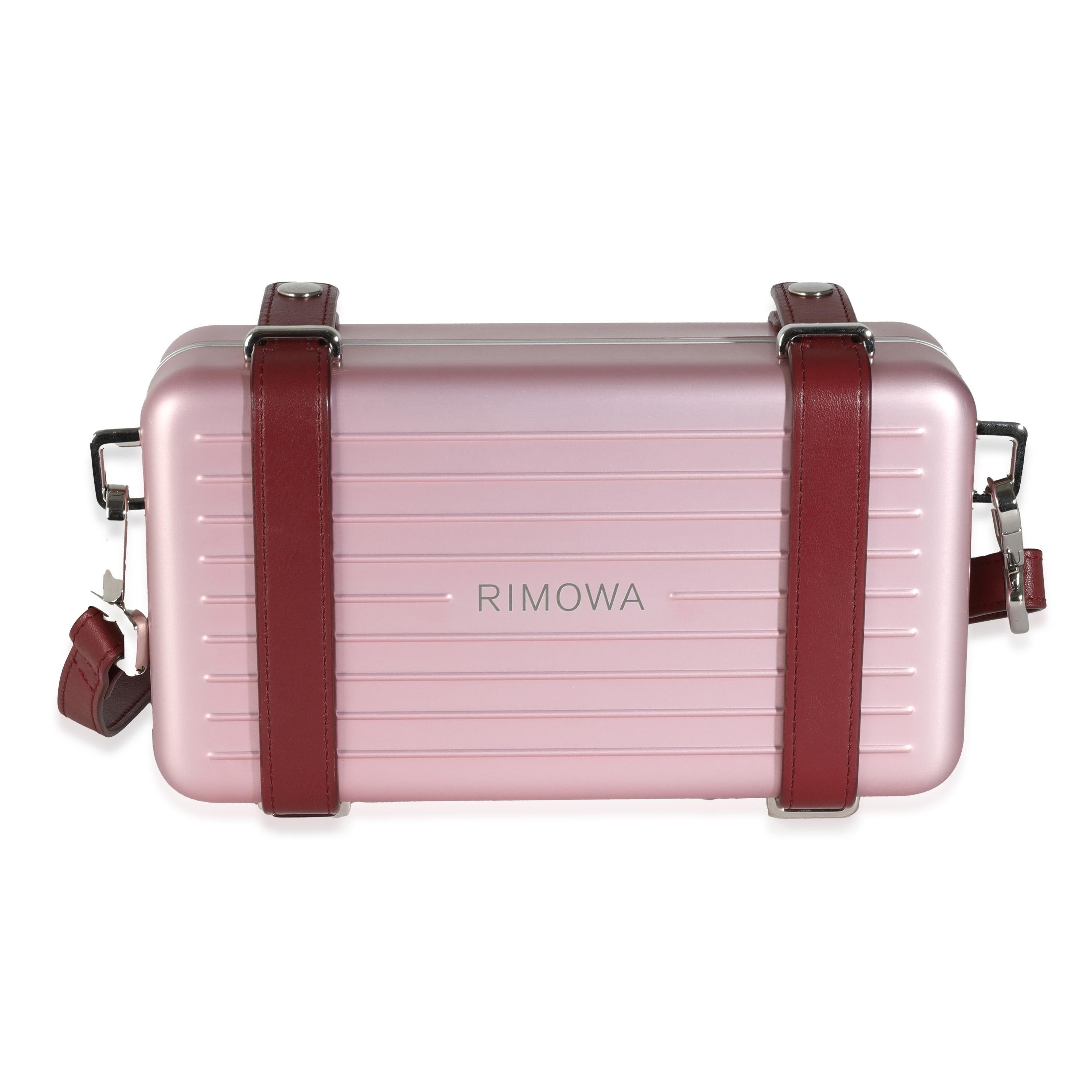 Listing Title: Dior x Rimowa Rose Aluminum Personal Clutch On Strap
SKU: 144296
Condition: Pre-owned 
Handbag Condition: Excellent
Condition Comments: Item is in excellent condition and displays light signs of wear.  Minor marks along strap. Light