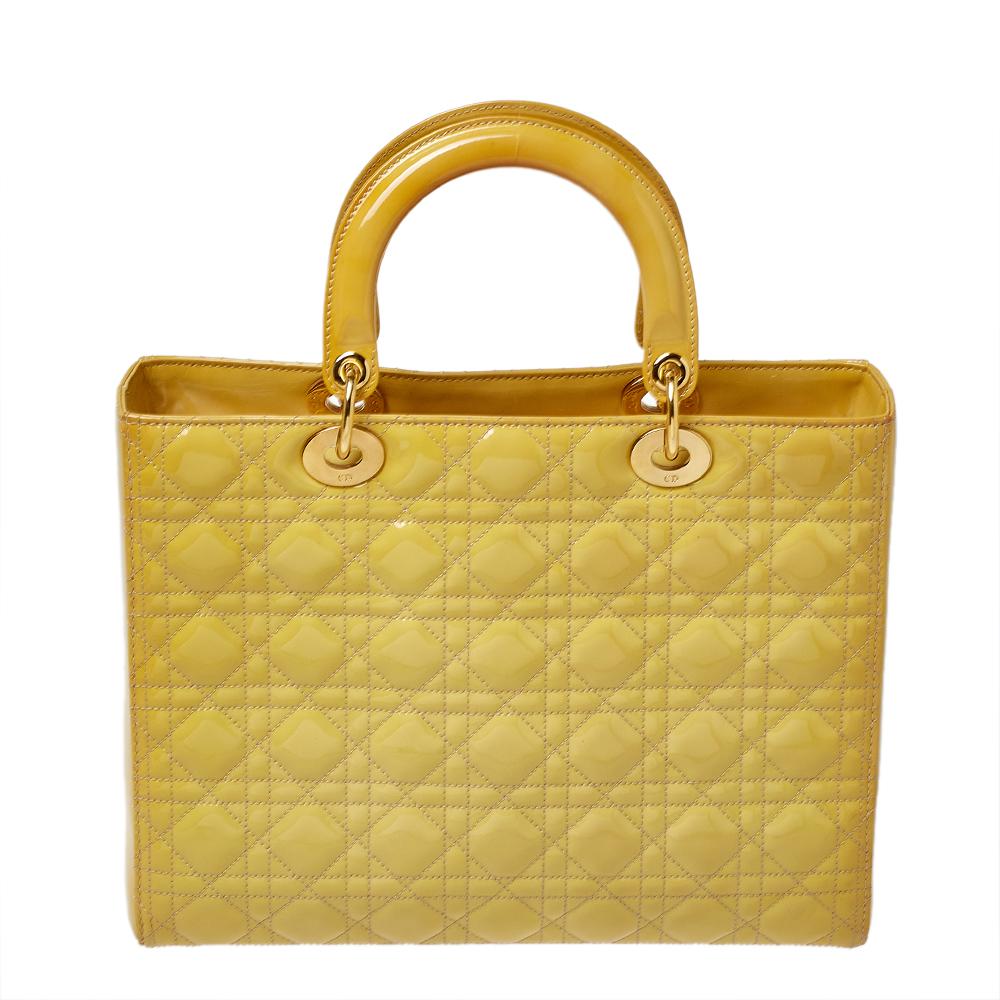 The Lady Dior tote is a Dior creation that has gained recognition worldwide and is today a coveted bag that every fashionista craves to possess. This yellow tote has been crafted from patent leather and it carries the signature Cannage quilt. It is