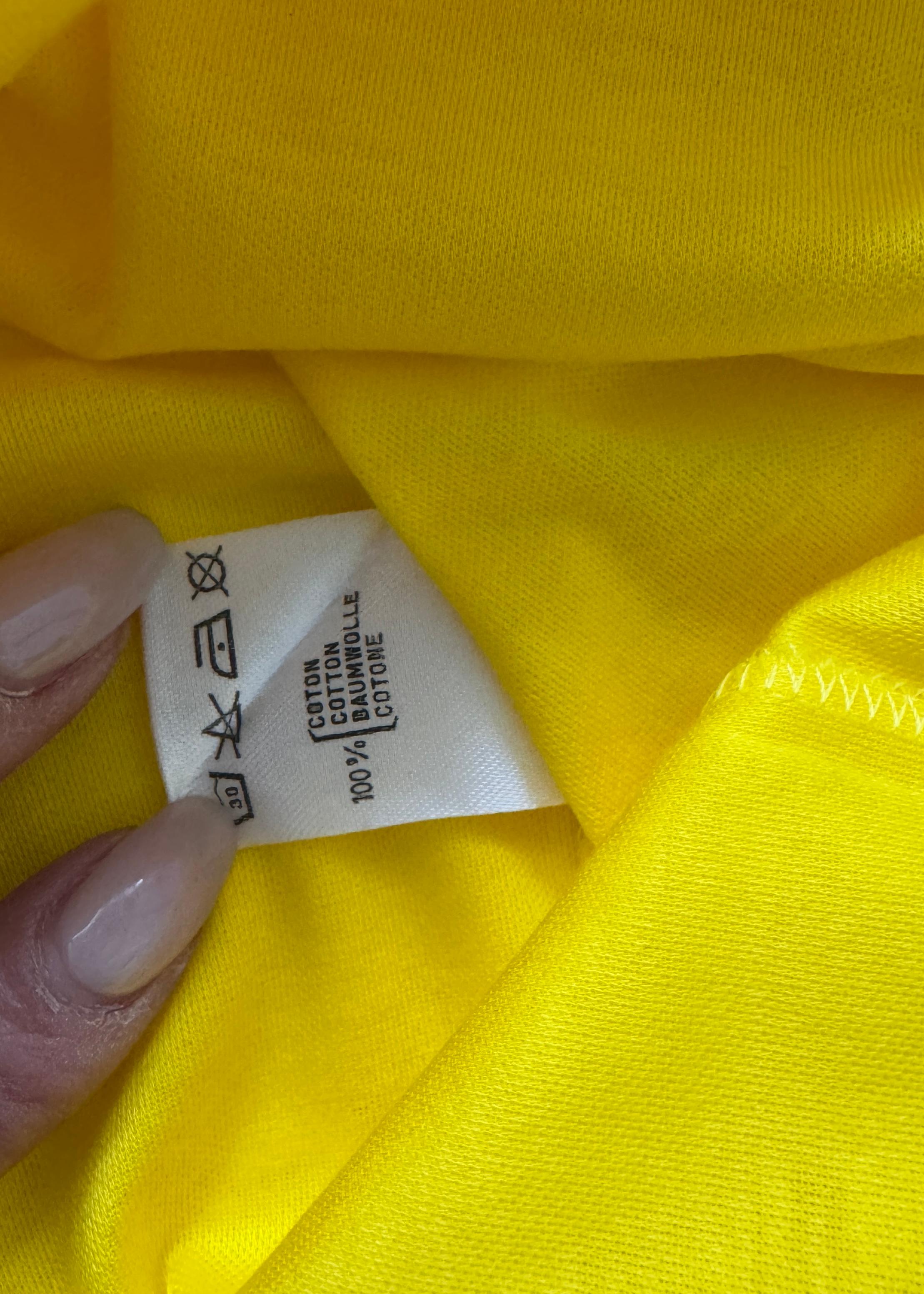 This rare vintage Dior T-shirt is a vibrant and playful piece from the early 2000s, showcasing the bold color palette and youthful spirit of the era. Made from a soft, breathable cotton-blend jersey in a striking sunshine yellow hue, it features a