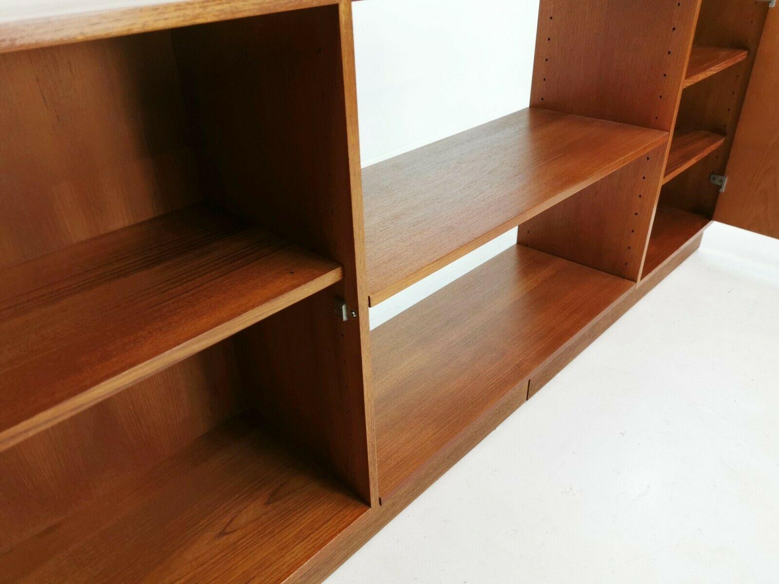A sideboard from the Diplomat series designed by Finn Juhl produced by Cado in Denmark in the mid-1960s.

Featuring two cabinets and a centre bookcase / display section.

Made in teak.

Measures: 74 cm height x 31 cm depth x 170 cm