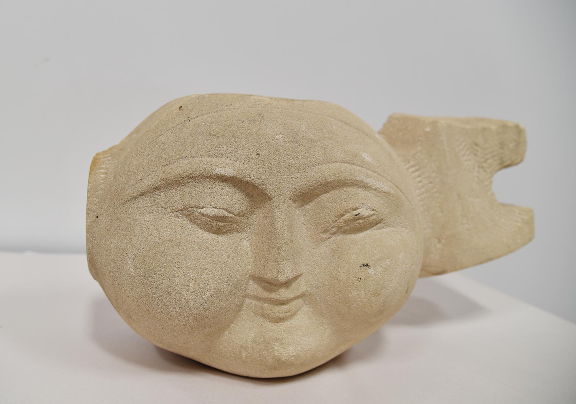 A hand-carved sculpture in sandstone styled after the head of DIRACCA from an unknown artist in Spain, circa 1940. This piece is stylized and attributed to Diracca from Spain in 1940. The site offers no possibility of listing this artist's name.
