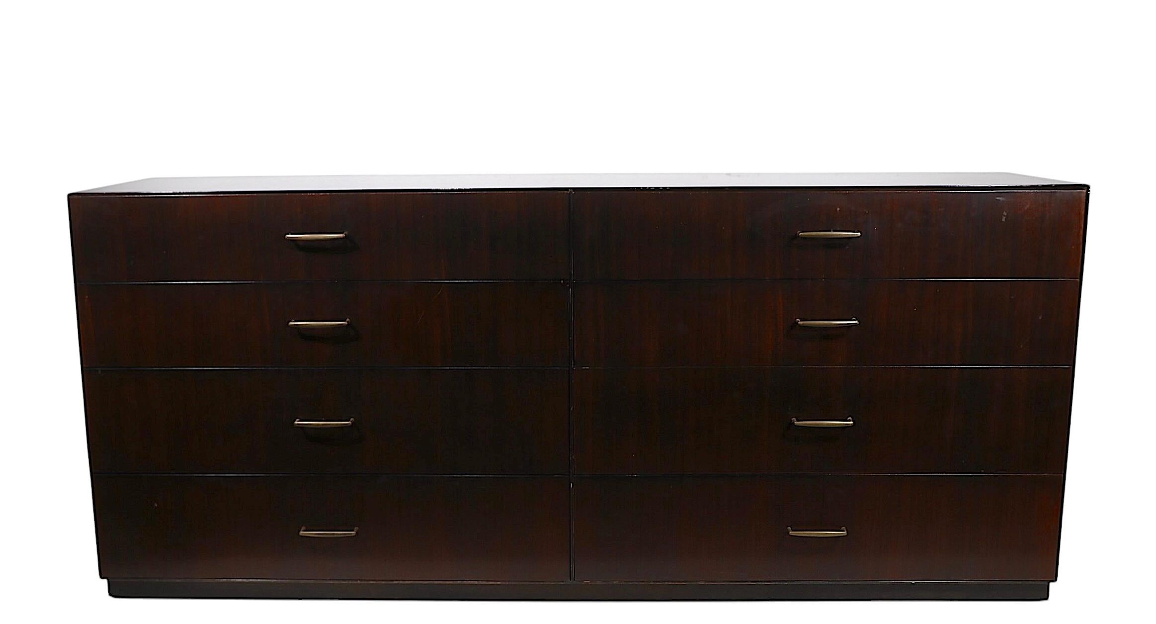 Eccezionale comò doppio di Directional, facente parte della classica serie Custom Collection, circa anni '70.
Questa imponente cassettiera è dotata di due banchi di quattro cassetti, con lussuosi  impiallacciatura in legno esotico, con tiranti