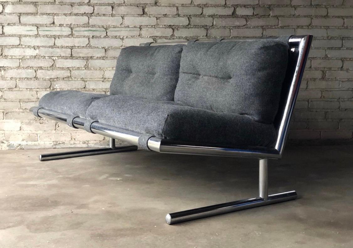 Designed by Arthur Umanoff for Directional Furniture in 1971, this loveseat features tubular chrome steel for its frame with the floating, armless design that has become ultra coveted in the past decade. The fabric is not original and would benefit