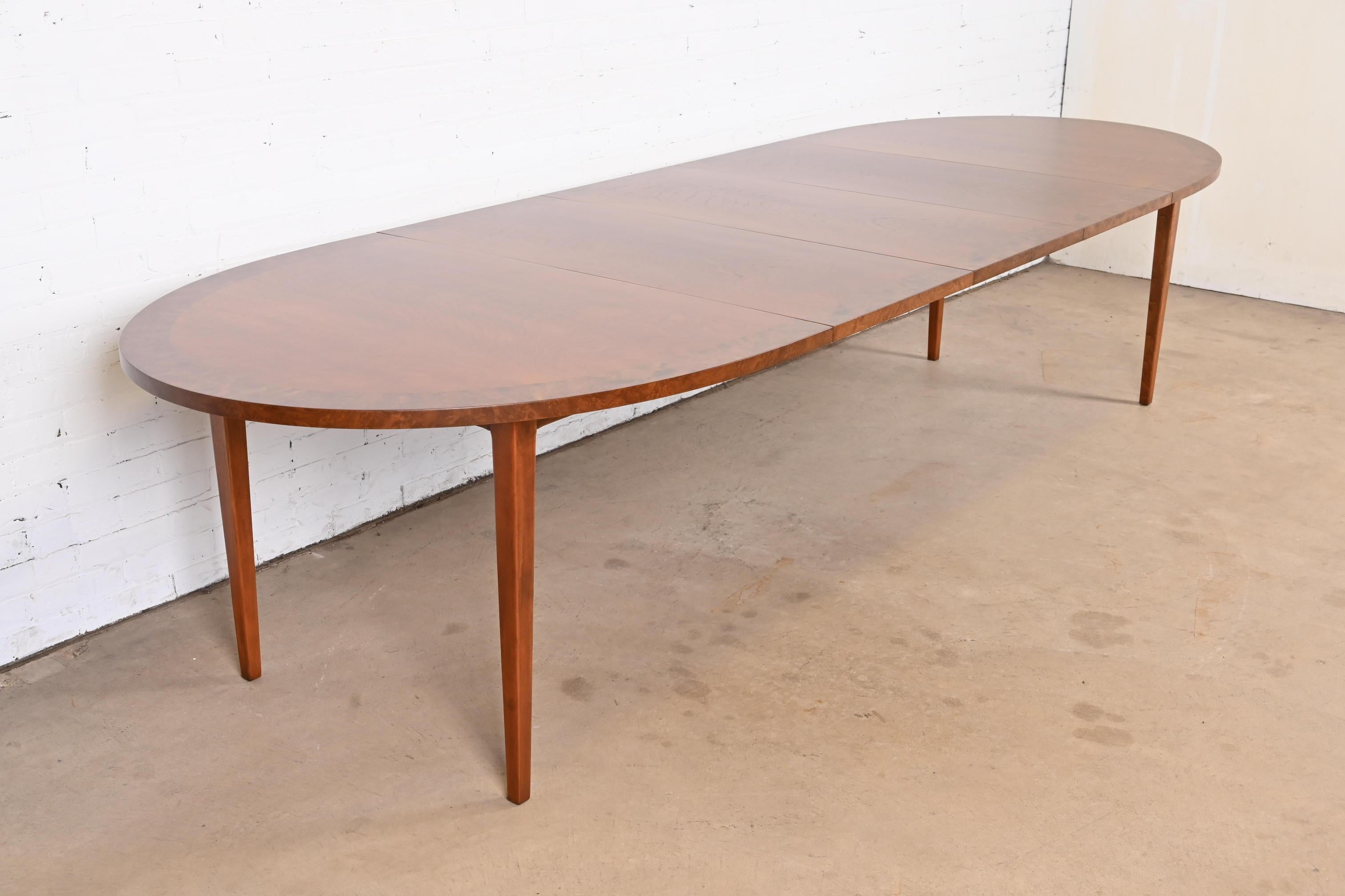 An exceptional Mid-Century Modern extension dining table

By Directional

USA, Circa 1960s

Gorgeous figural cherry wood, with burl wood banding.

Measures: 72