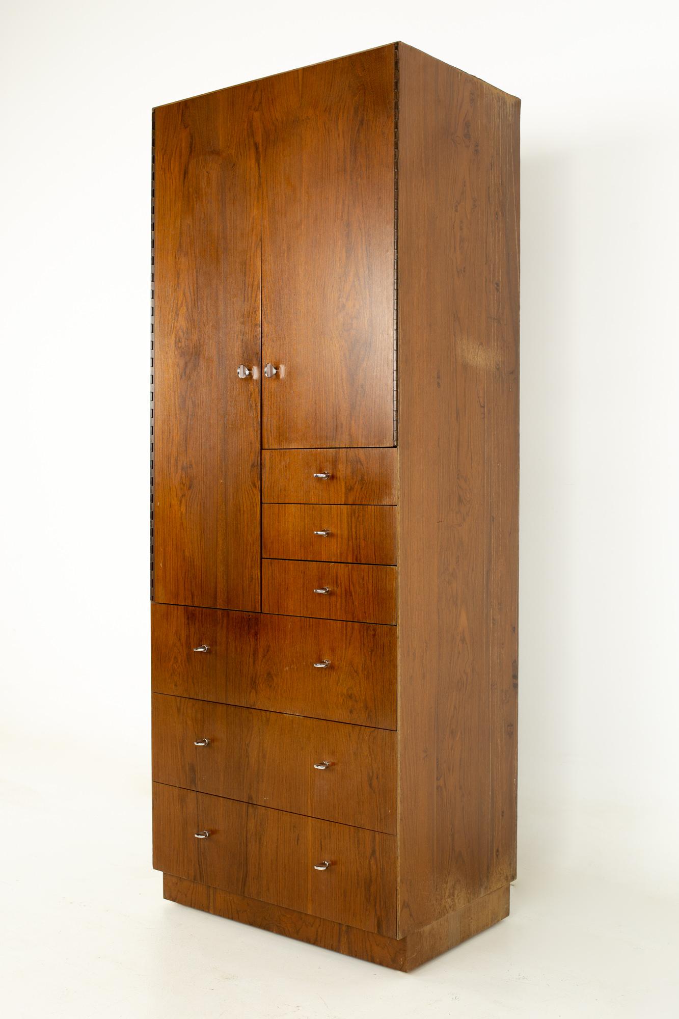 Directional mid century walnut and chrome armoire dresser
This dresser measures: 27 wide x 18 deep x 70.5 inches high

All pieces of furniture can be had in what we call restored vintage condition. That means the piece is restored upon purchase