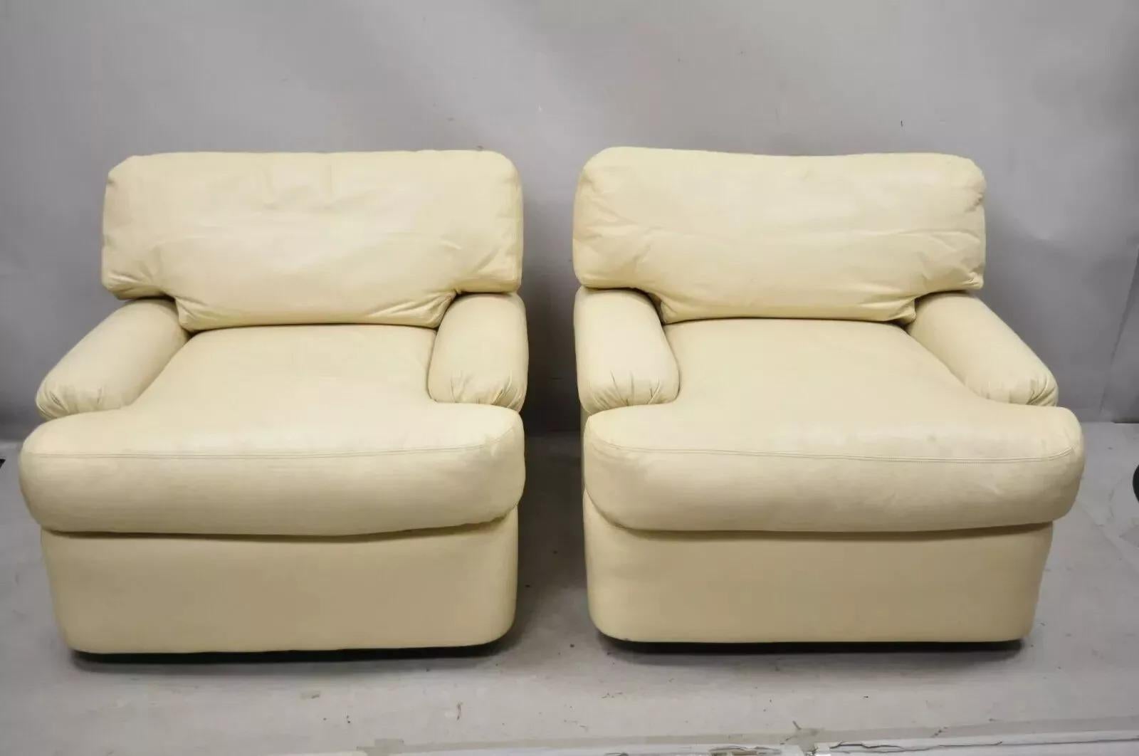 Milo Baughman for Directional Swivel Beige Leather Club Lounge Arm Chairs - a Pair. Item features large swivel and return frames, beige high quality leather upholstery, original labels, clean modernist lines, great style and form. Attributed to Milo