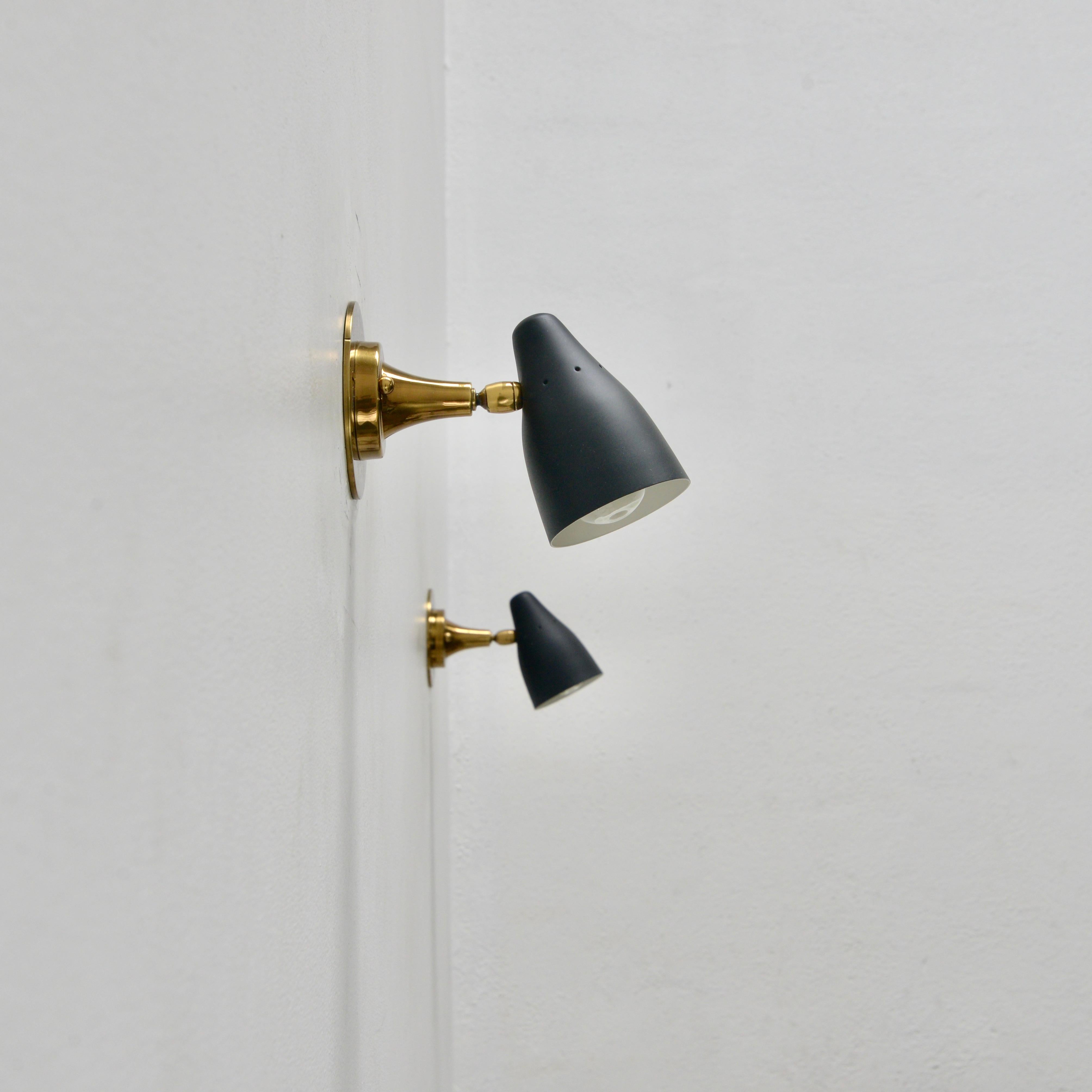 Pair of black and brass directional Italian sconces by Ostuni from the 1950s. Partially restored. (1) E12 candelabra based socket per sconce. Wired for use in the US. Lightbulbs included with order. Sold as a pair.
Measurements:
Height 5”
Depth