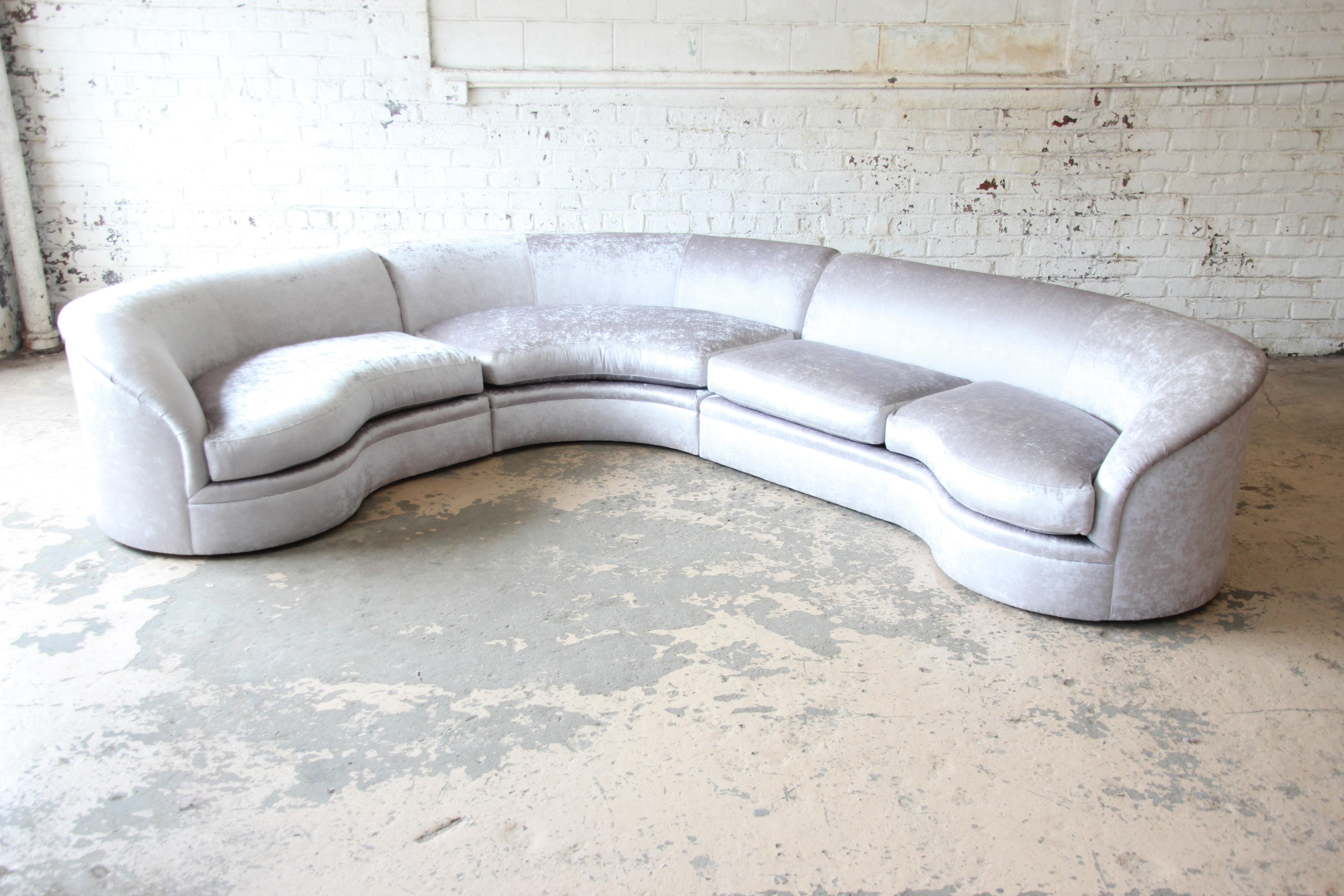 An outstanding three-piece curved sectional sofa by Directional. The sofa has been expertly restored by Comfort Upholstery of Chicago, newly reupholstered with a very high-end sleek silver gray velvet upholstery by Holly Hunt. This 1970s sectional