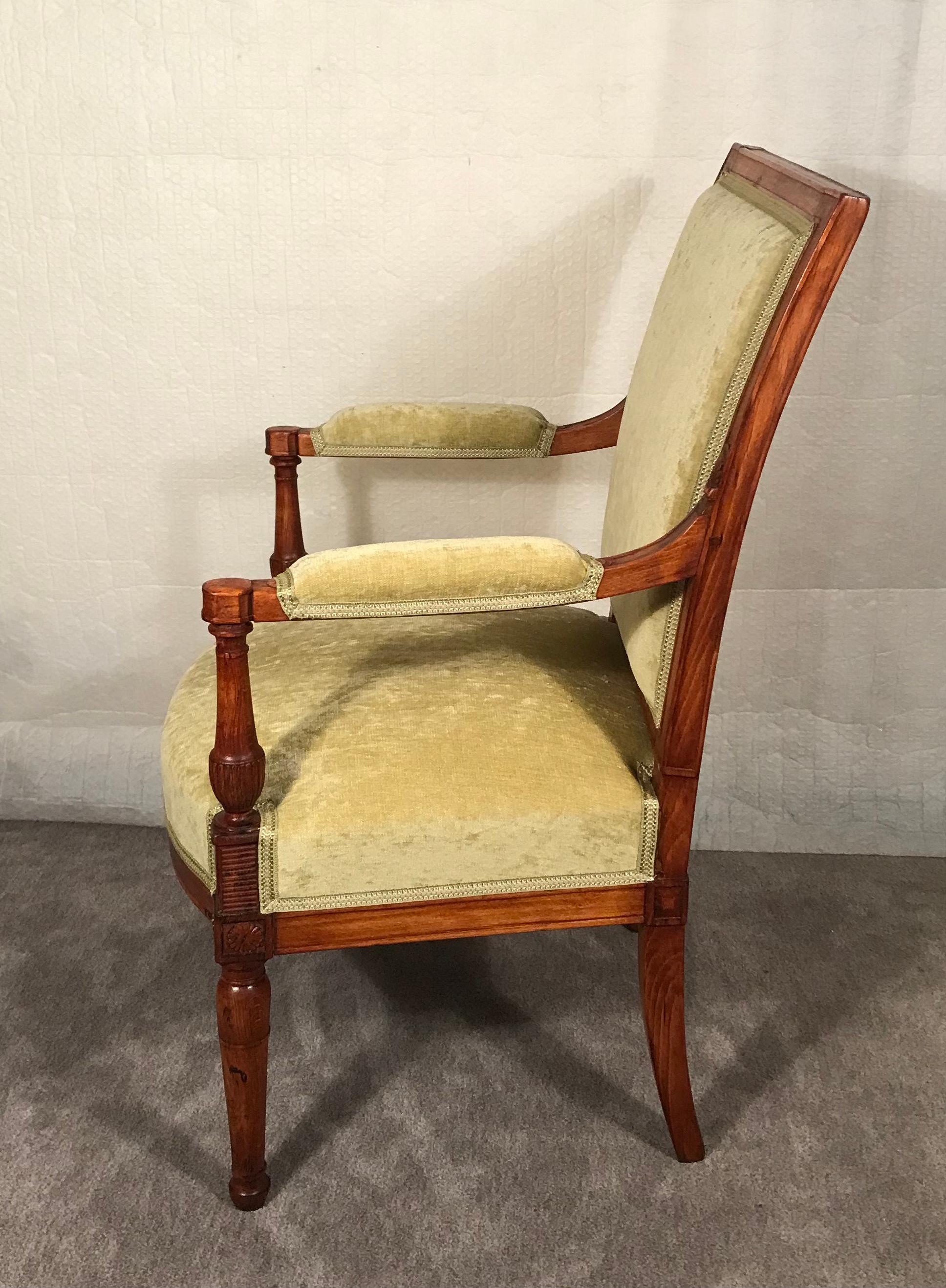 Discover the elegance and historical charm of this Directoire armchair, originating from France around 1800. This piece showcases a meticulously carved walnut frame, reflecting the refined craftsmanship of the period.  Features:  
Elegant Design: