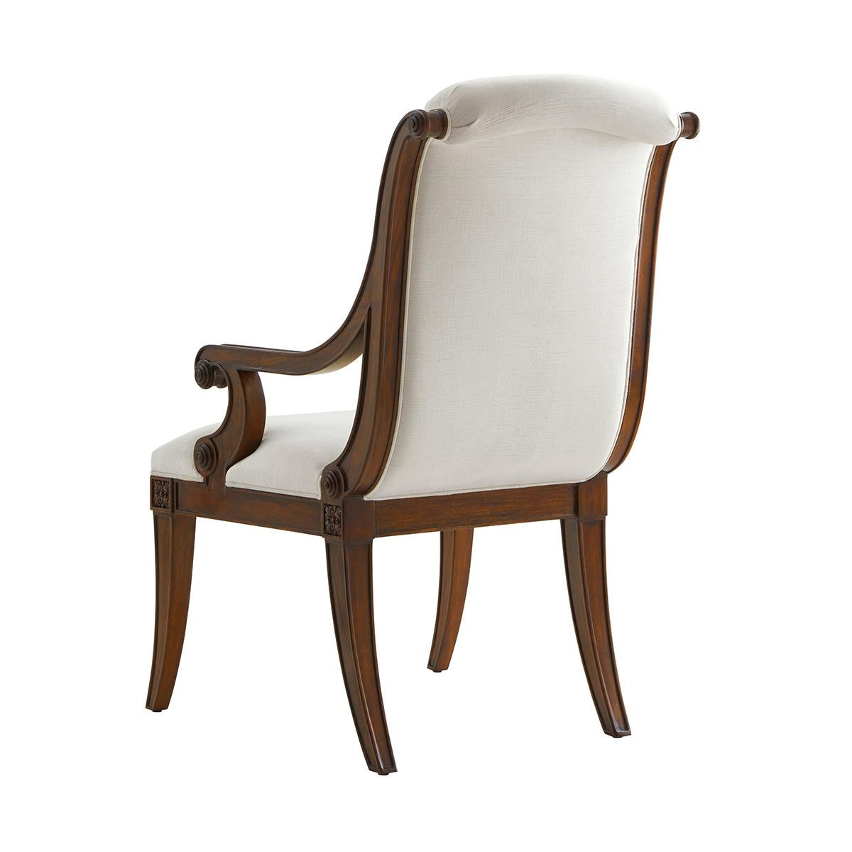Two mahogany armchairs, with an over scroll padded back and seat between open scroll arms and above floral capital carved and paneled sabre legs. Inspired by a 19th-century French original.

Dimensions: 25.25
