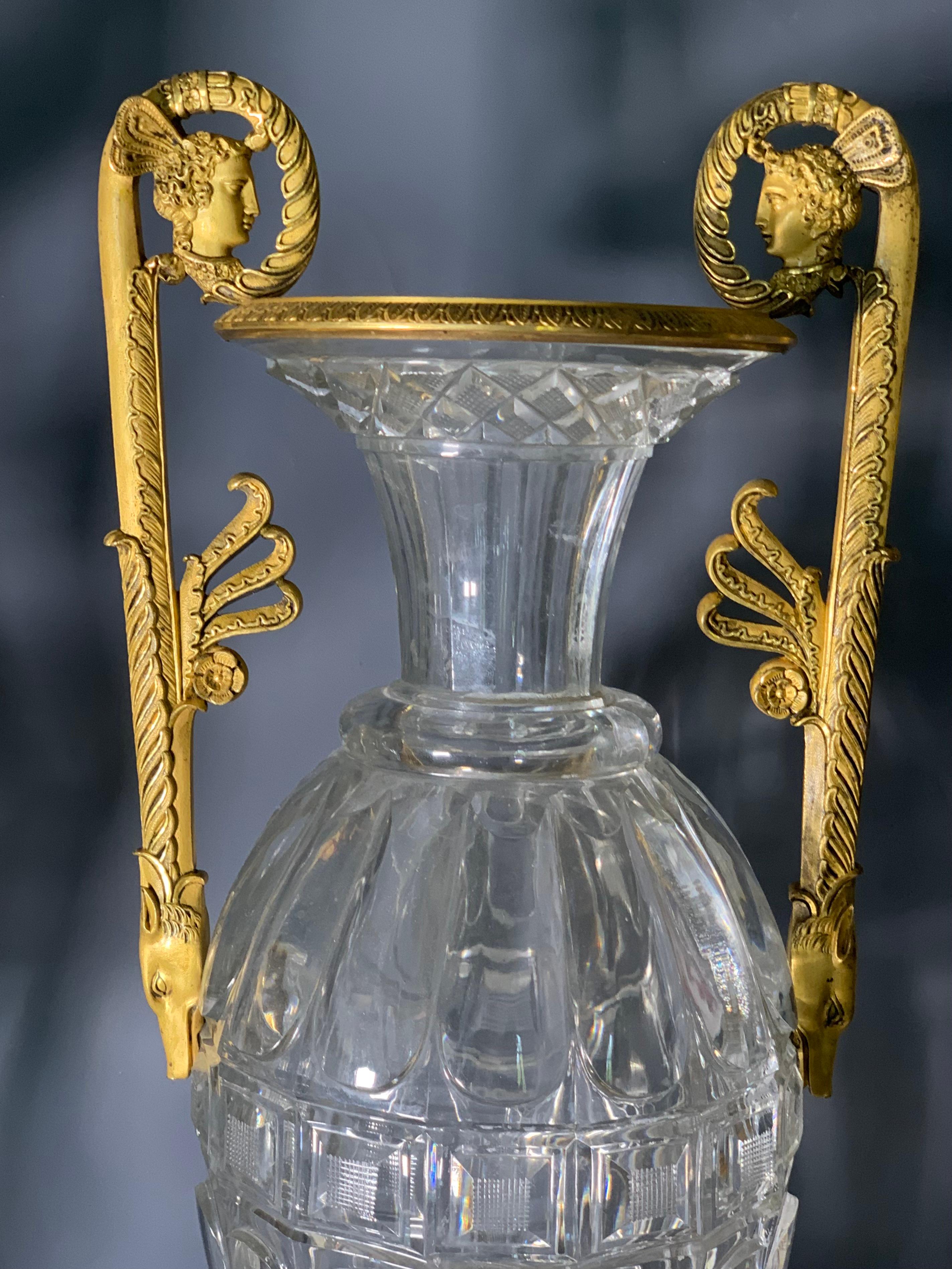 Outstanding  spindle vase in heavy cut crystal. 
Probably Cristallerie du Creusot  (Baccarat) or  Imperial Glassworks de Saint-Petersourg, around 1800.
The fixture with antique profiles and wolf's heads , original mercury ormolu, of high quality can