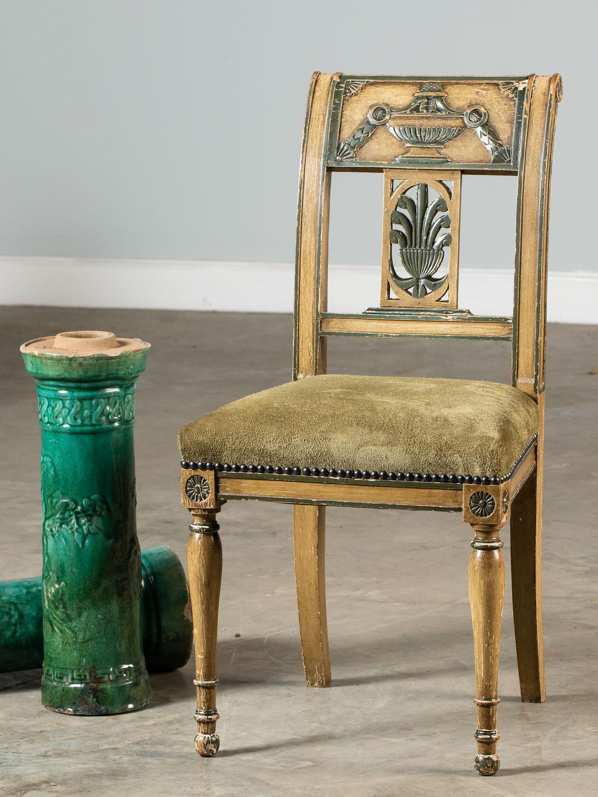 A Directoire Empire style painted side chair from France, circa 1850. Please look closely at the distinctive design details that comprise the makeup of this chair. The two front legs have an elegant shape created from a single piece of timber that