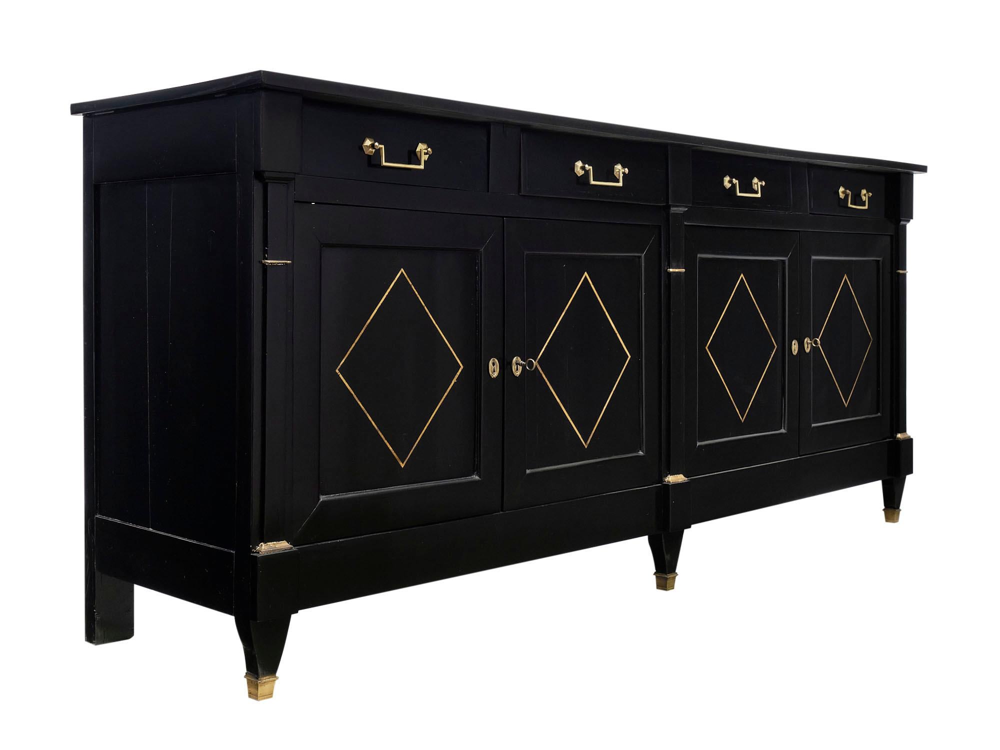 Directoire style French ebonized buffet made of solid cherrywood paneling and pegged construction. There are four dovetailed drawers above four doors with gold leafed details and bronze hardware. The fruit wood has been ebonized and finished with a