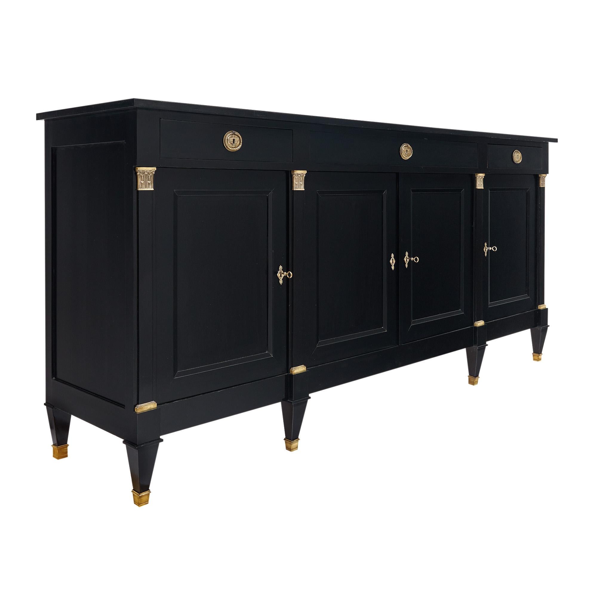 Buffet from France in the Directoire style. This piece is made of solid wood construction, primarily mahogany. This piece has been ebonized and finished with a lustrous French polish of museum-quality. At the top, there are three dovetailed drawers.