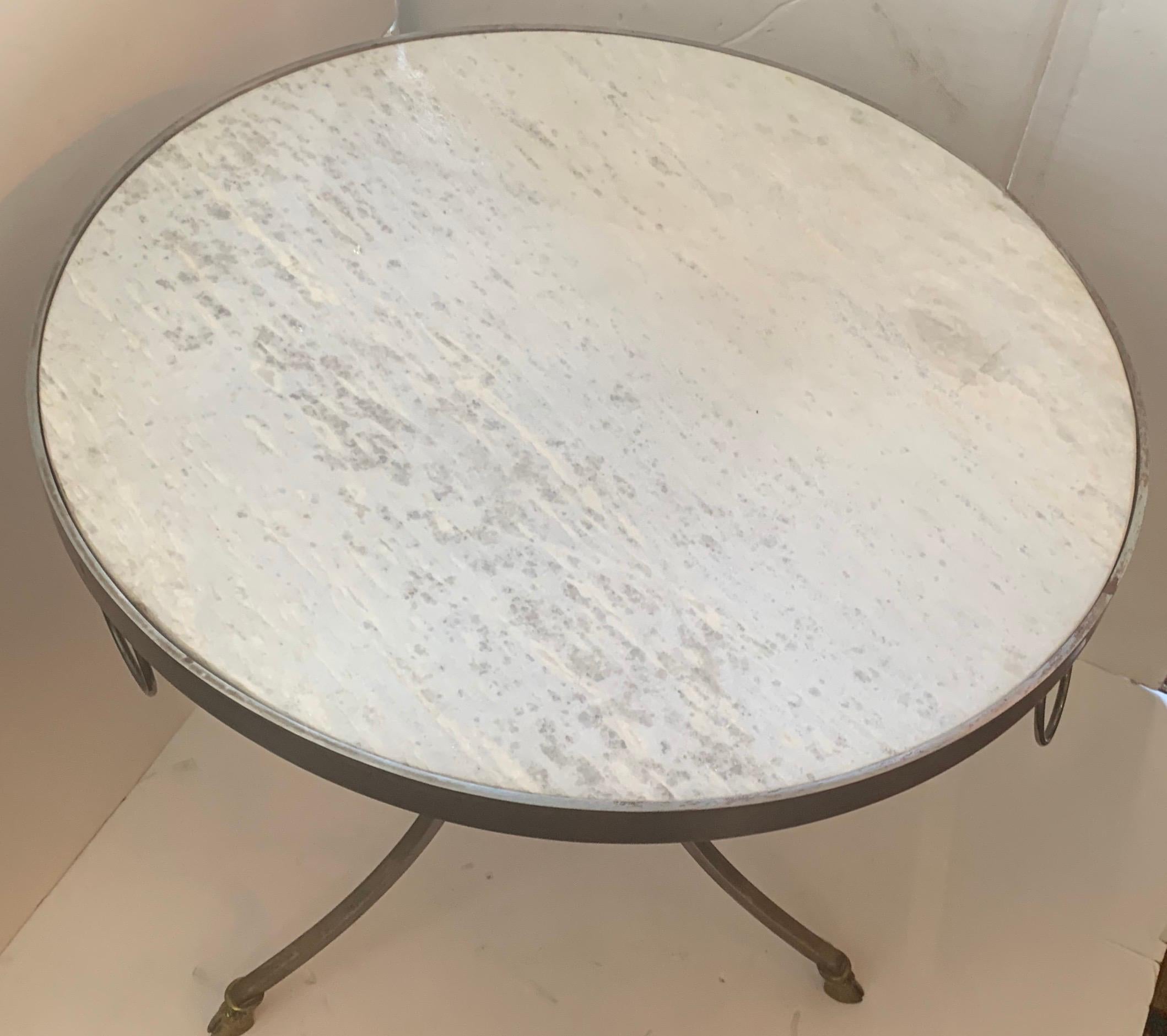 A wonderful Directoire French Louis XVI neoclassical Maison Jansen style guéridon marble-top table with brushed nickel / stainless steel frame and bronze rings and feet.
       