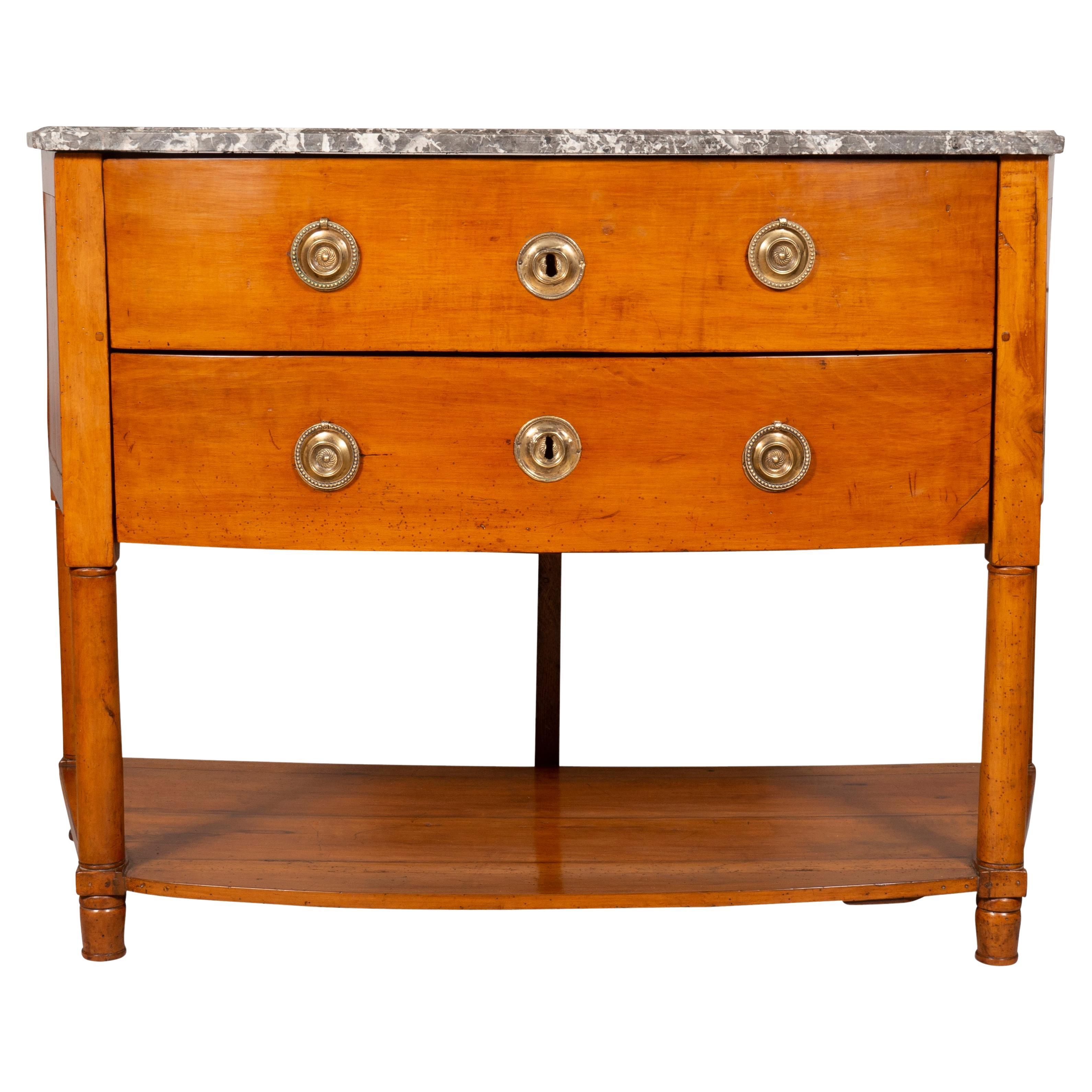 With original bowed St Anne marble top over two conforming drawers with round brass handles, lower conforming shelf and ending on turned feet. From the estate of William Hodgins noted interior designers Manchester Ma summer home. With key.