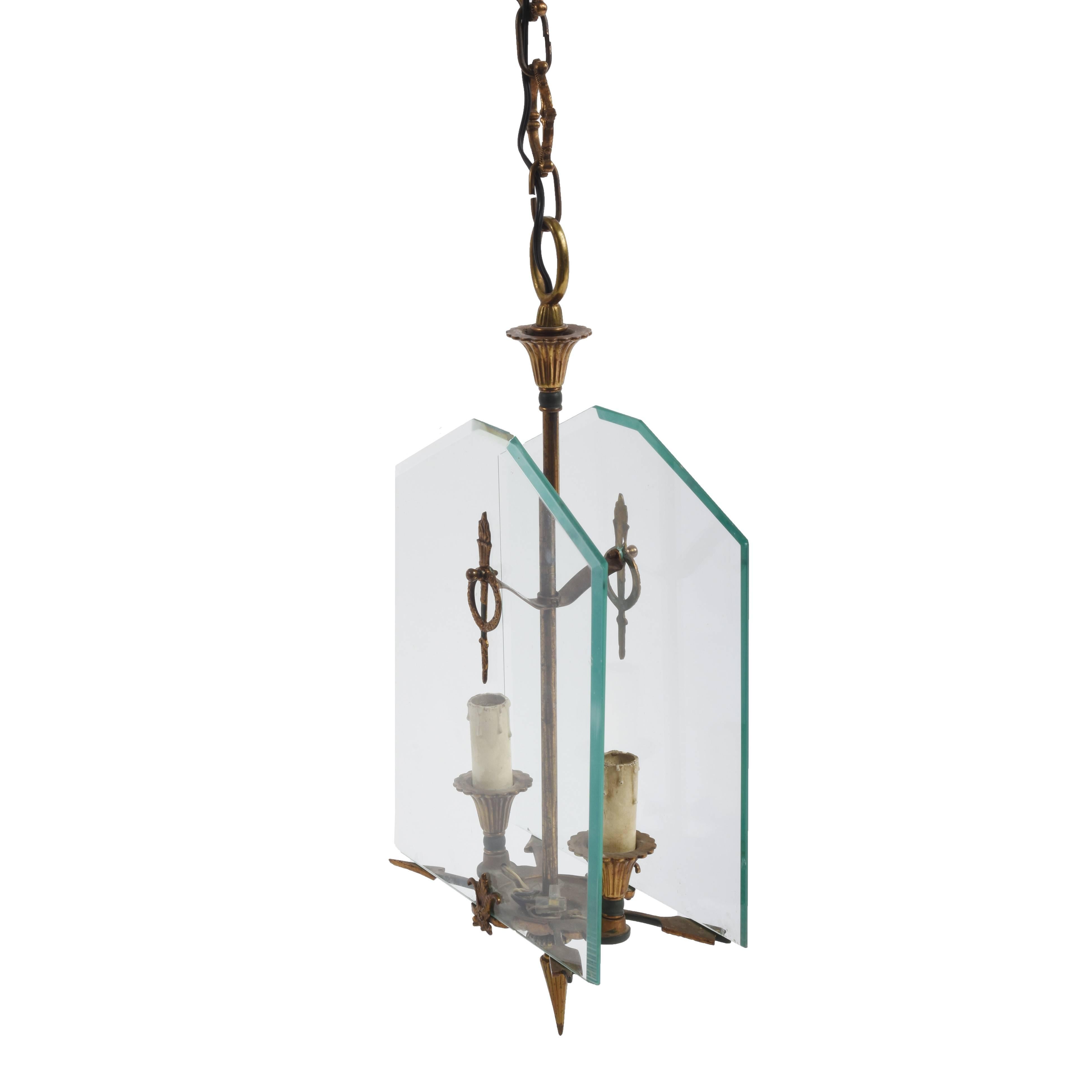 Two-light chandelier in enameled gilded bronze and Directoire style glass.

This item is in the style of Fontana Arte, a leading lighting production and design company during the 1930s. You can find clearly elements of inspiration by watching how
