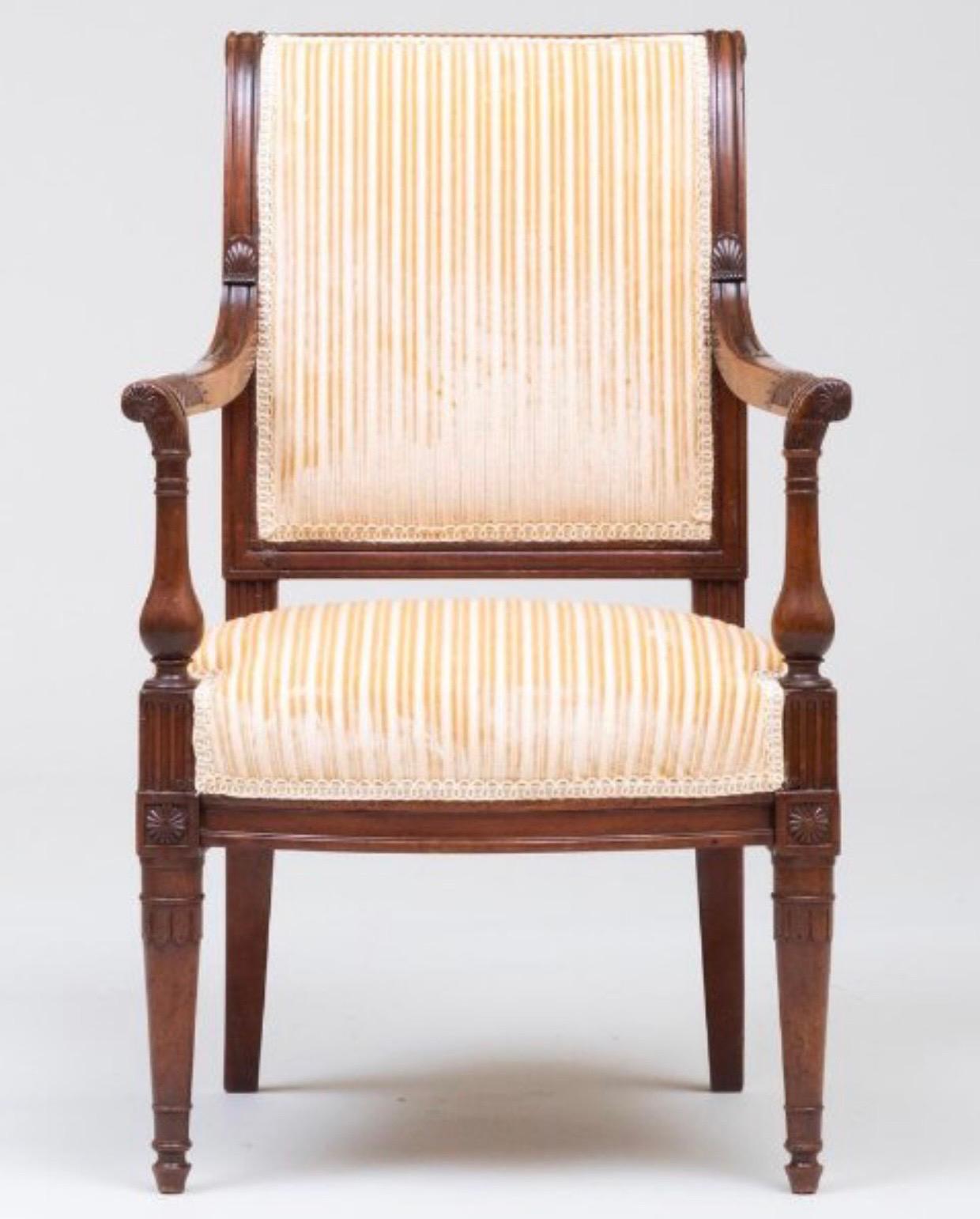 The diminutive armchair with wear consistent with age and use.
 