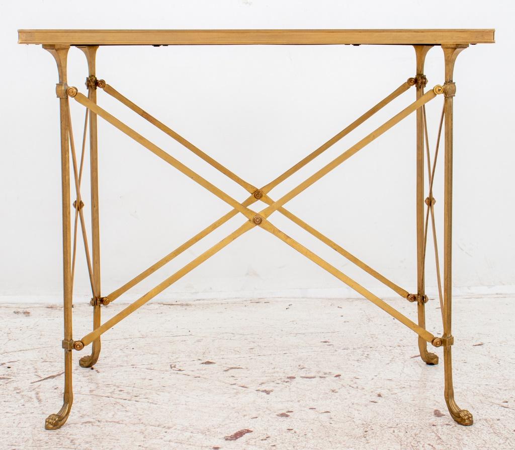 Directoire style marble topped ormolu side table in the manner of Maison Jansen, with rectangular Carrara marble top and featuring a metal reeded style frame with lion paw feet.
26.5