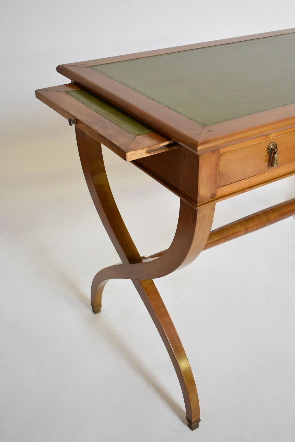 Neoclassical curule Directoire stye desk console table opening with two drawers ornamented with pompons handles in the front belt, and two extensive shelves on each side. France, 1970s.