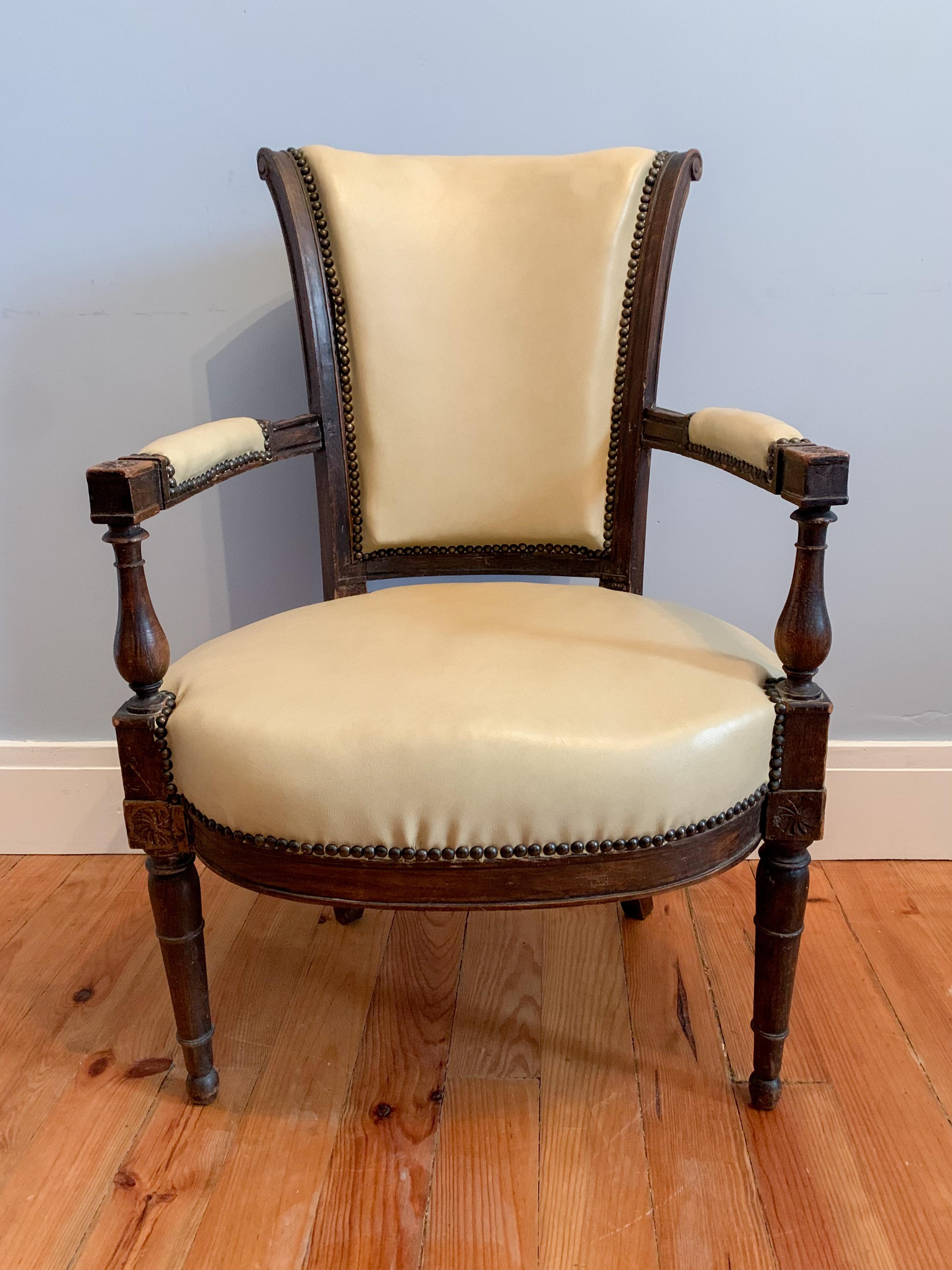 This nice chair of directoire style is characterized by straight and simple forms. The uprights are made of turned wood with floral motifs on the connecting dice (seat and armrests). 

France 19th century.
 