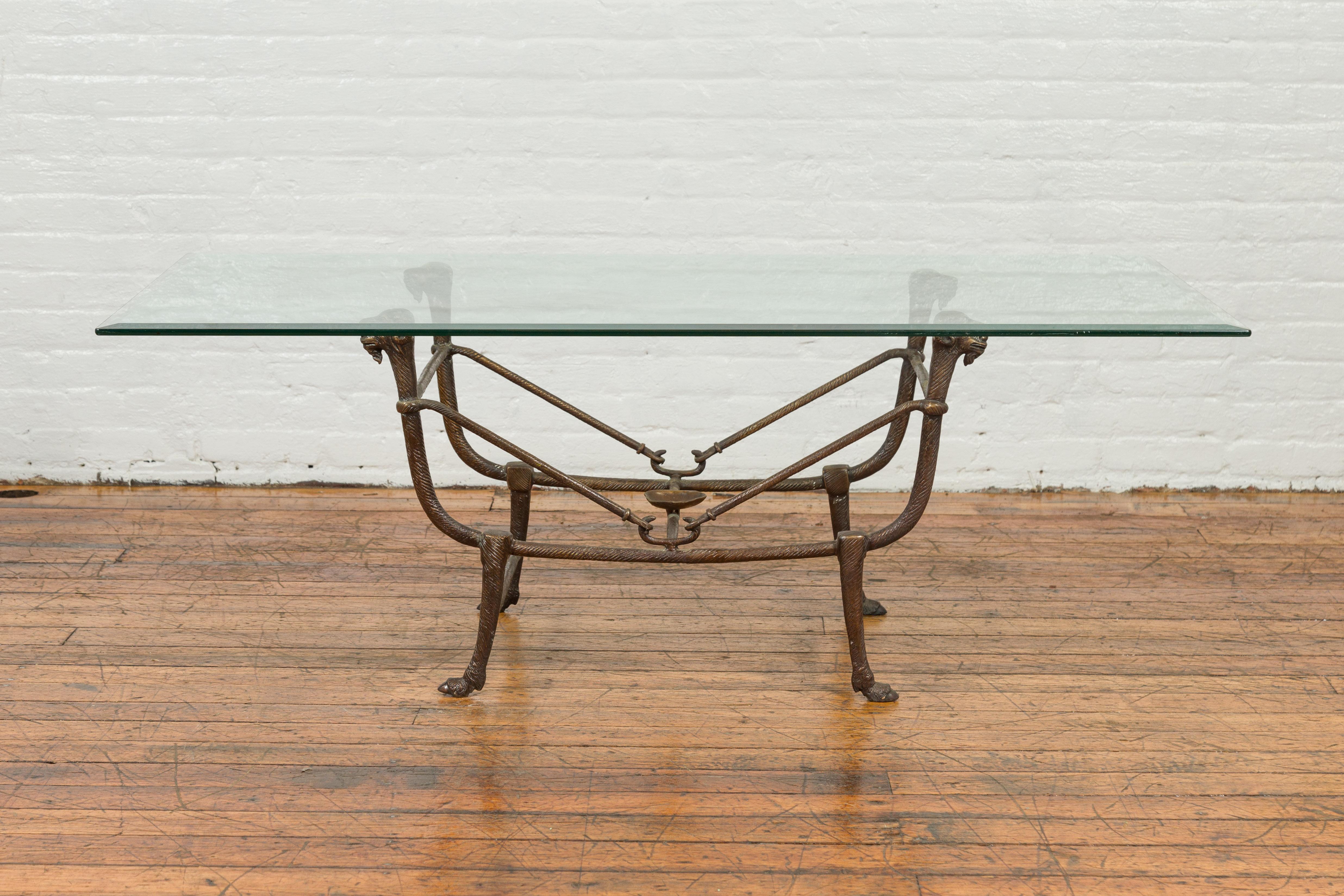 A contemporary bronze Directoire style coffee table base from the 20th century with ram’s heads and dark patina. The tabletop is not included but shown on the photos to allow better visualization of the possibilities. Created with the traditional