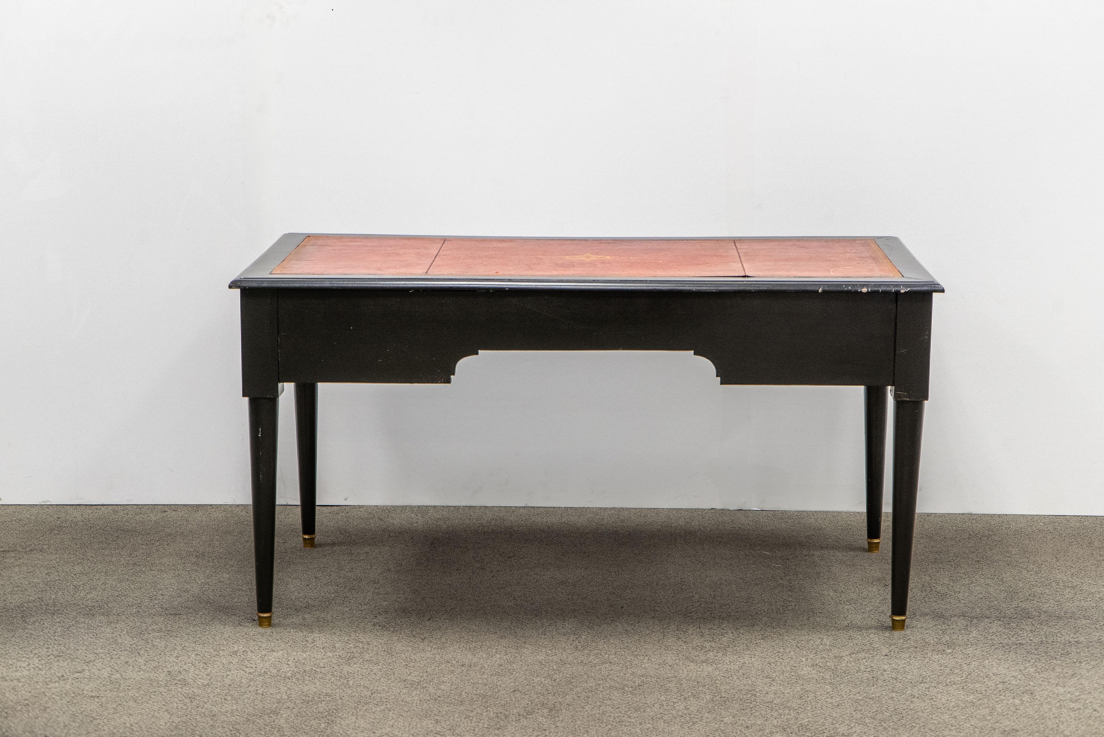 Directoire/Napoleon III style desk composed of one large center and two side dovetailed drawers. The right drawer has a divided back section with an inset tray and a horizontal panel that slides over the top of the section to lock (no key). Brass