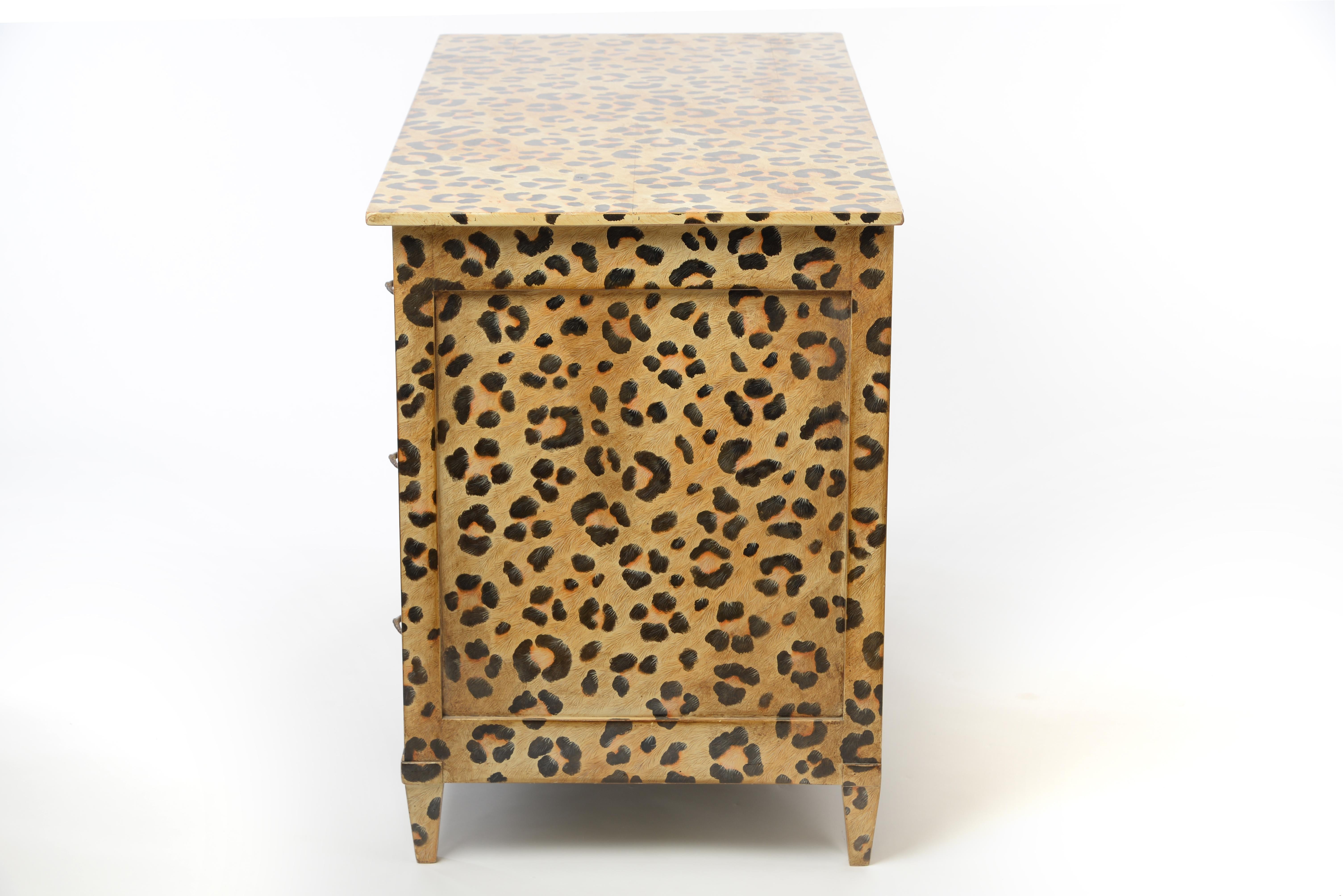 This exceptional chest of drawers with its stunning hand painted leopard pattern offers 3 large drawers with beautiful bronze hardware. The short, straight legs and the overall straight form give this piece a contemporary feel while still staying