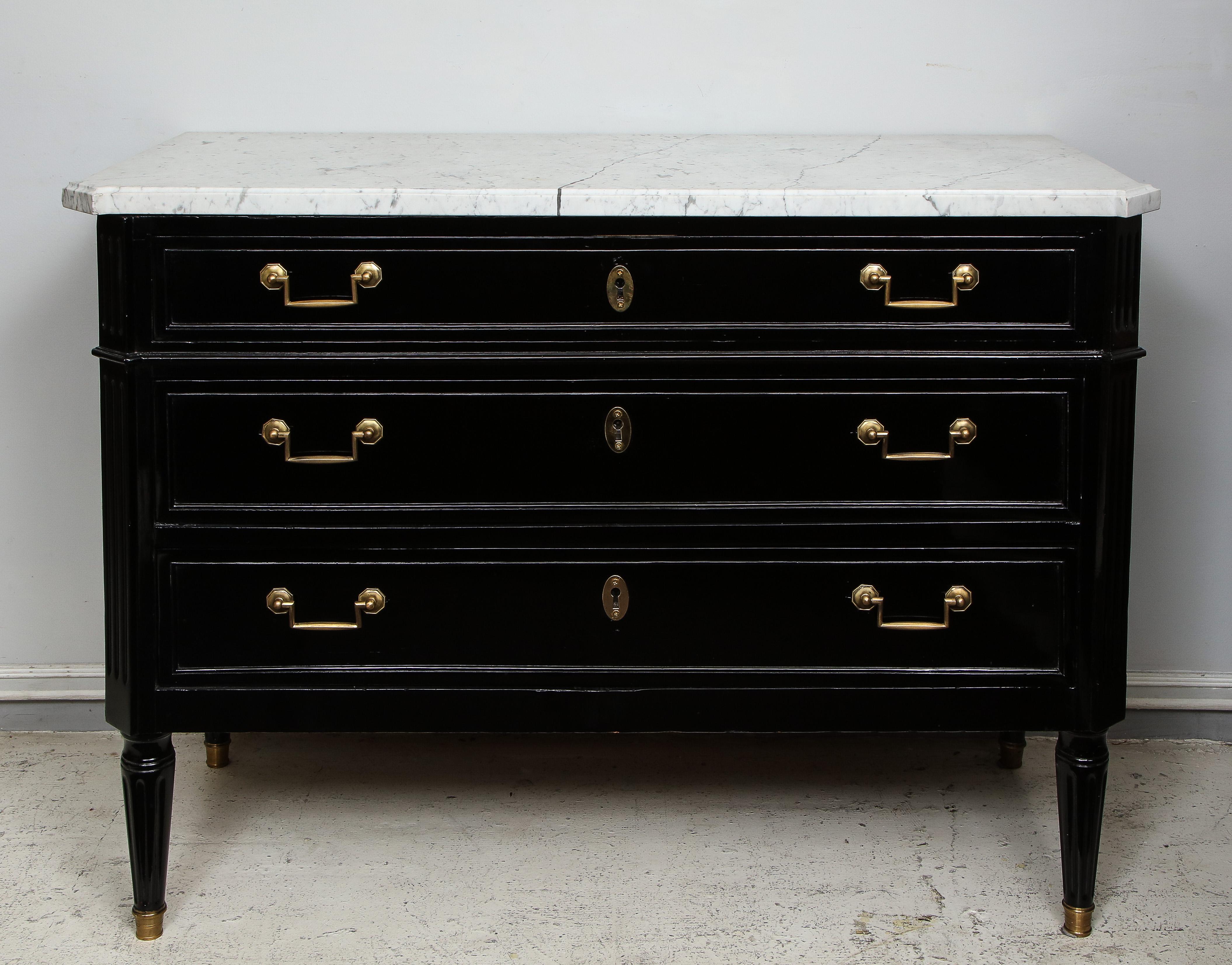 Directoire- style commode with marble top on tapered legs.