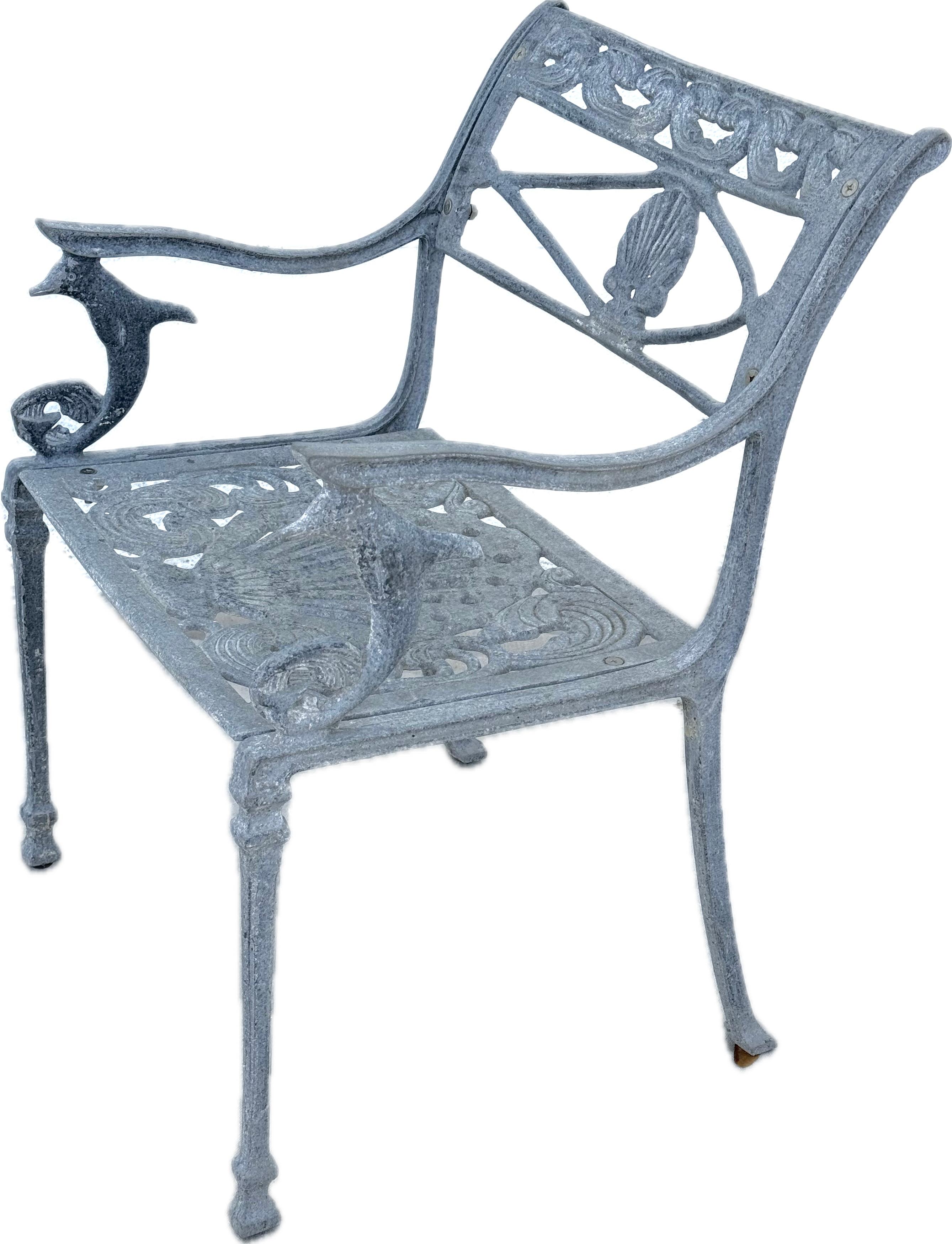 Unique 20th century Directoire Style Dolphin And Shell Garden Patio Armchair. Chair is made of cast aluminum featuring dolphins on each arm and a center shell back as well as a large shell seat. They are of solid construction with a vintage matte